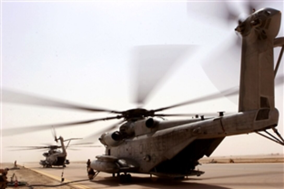 Two CH-53E Super Stallions refuel after inserting about 46 U.S. Marines into a combat zone in Al Anbar province, May 8, 2008, to search for hidden weapons caches. The Marines are assigned to the Marine Heavy Helicopter Squadron 462, 3rd Marine Aircraft Wing.