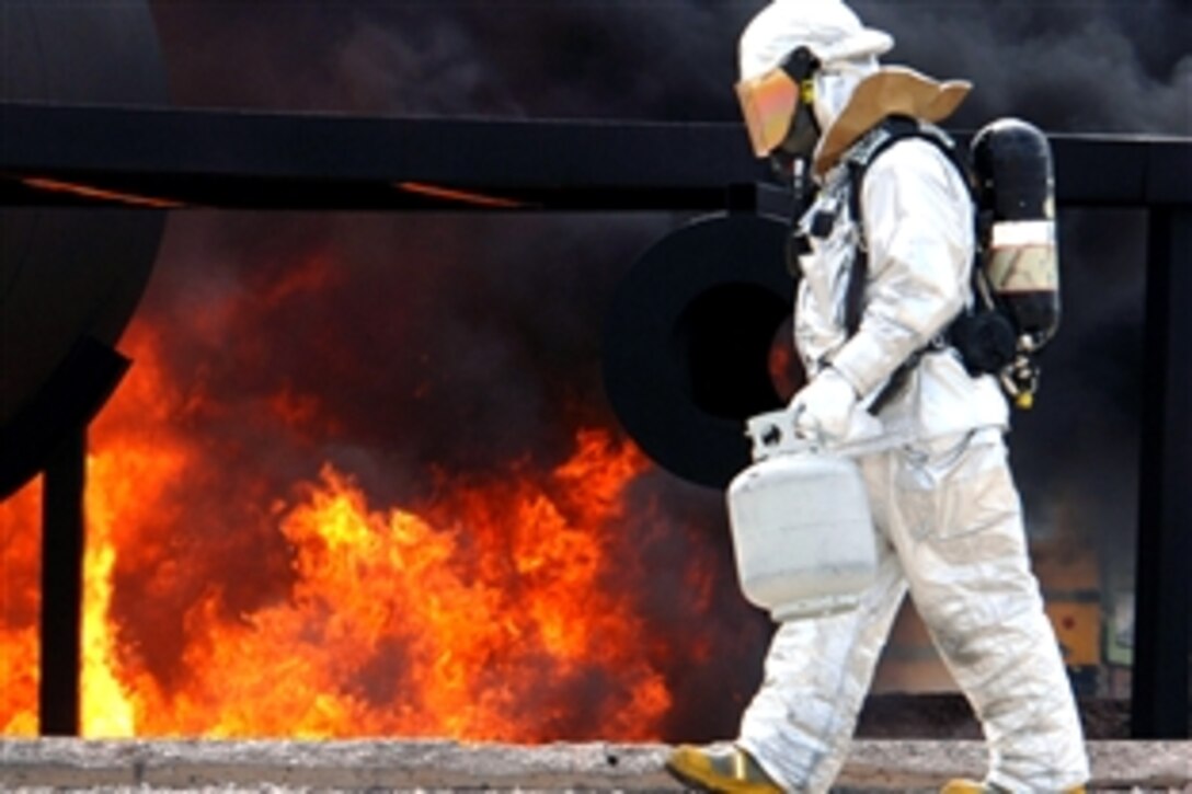U.S. Air Force Staff Sgt. Kristian Voth uses a propane lighter to fuel a training fire on Ellsworth Air Force Base, S.D., May 13, 2008. Voth is a firefighter crew chief assigned to the 114th Fighter Wing, 114th Civil Engineer Squadron. 