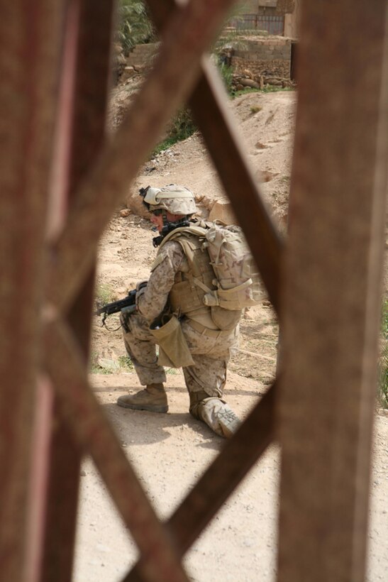 Seaman Anthony A. Abeyta, 20, a rifleman with Company K, 3rd Battalion, 4th Marine Regiment, Regimental Combat Team 5, from Clayton, Calif., provides security during a census patrol in the city of Bani Dahir, Iraq. Marines with Company K walked through the city questioning multiple people about their feelings towards Marines and Iraqi Policemen. Marines also handed out candy to children in the city during the patrol. The people interviewed had nothing but positive things to say about Marines and the IP.