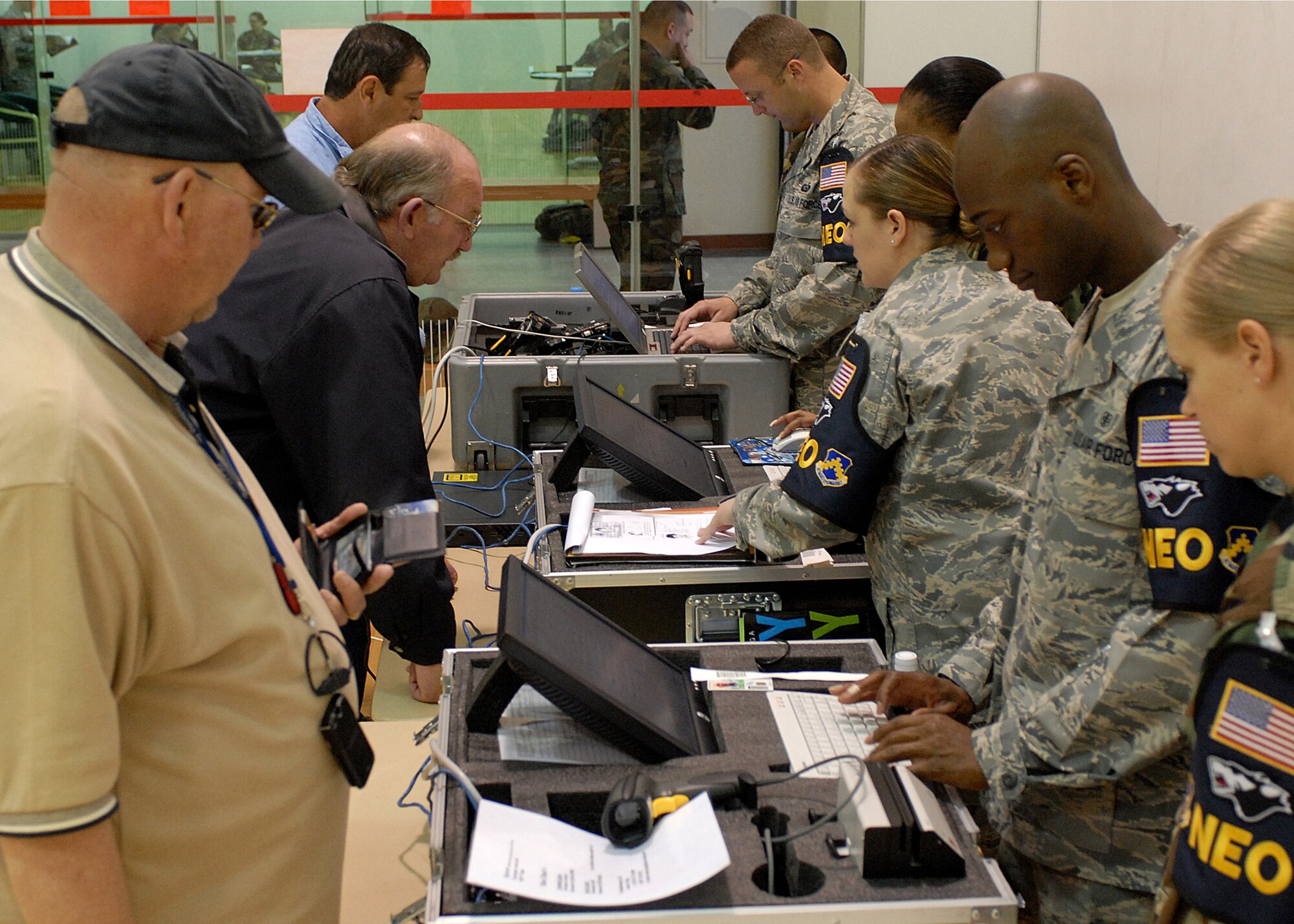 KUNSAN AIR BASE, Republic of Korea -- The Non-combatant Evacuation Operations team processes Department of Defense civilians during Courageous Channel here May 16. The NEO is designed to evacuate Department of Defense affiliate civilians in case of emergency events such as natural disasters or war.  The NEO exercise team takes accountability of all DoD civilian personnel, keeps track of their information and transports all their personal household belongings.  (U.S. Air Force photo/Senior Airman Giang Nguyen)