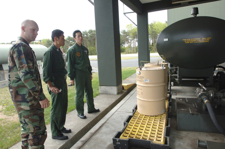 MISAWA AIR BASE, Japan -- Tech. Sgt. Marcus Sydow, 35th propulsion shop non-powered age NCOIC, briefs Japanese Air Self Defense Force Tech. Sgt. Takuma Ota (center), and Staff Sgt. Masanobu Suzuki (right), on the capabilities of a fuel tank on the flightline May 15, 2008. Misawa Air Base has been apart of a bilateral exchange for 11 years and this is the first involving local JASDF.  (U.S. Air Force photo by Senior Airman Robert Barnett)
