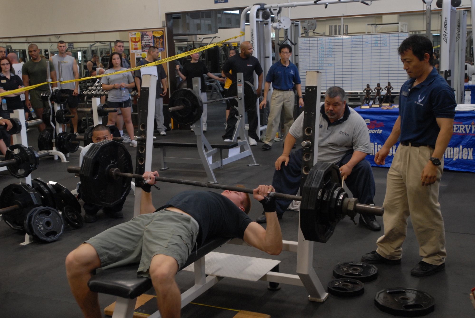 Judges and spectators watch as Cameron Elvin attempts a lift during the bench press competition. Points were calculated using the Schwartz/Malone formula, a standardized formula for bench press competitions.
(U.S. Air Force/Staff Sgt. Darnell Cannady)