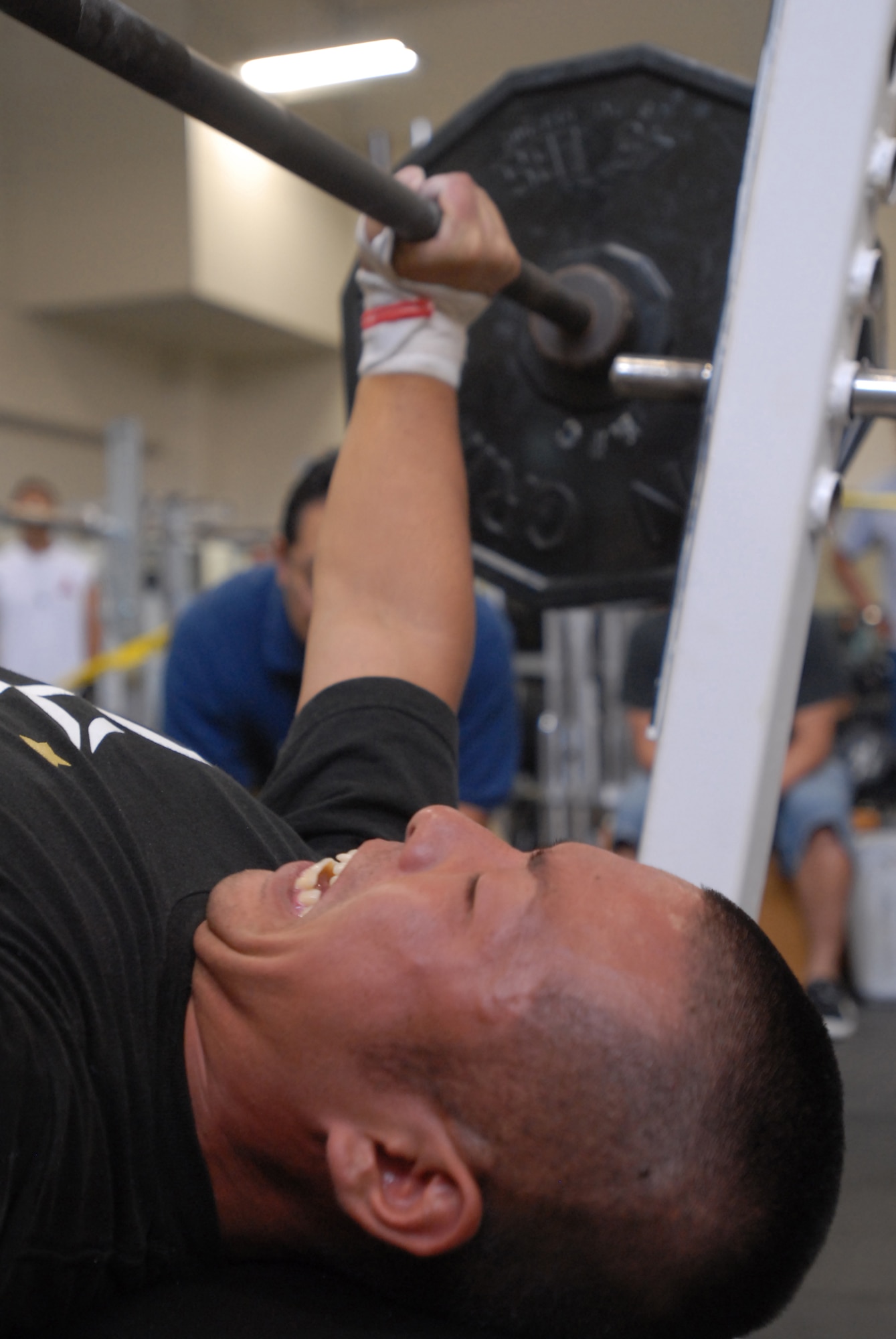 Hirota Kinashita attempts a lift during the bench press competition at the Risner Fitness Center May 10. Competitors bench-pressed for three rounds before entering a final round.
(U.S. Air Force/Staff Sgt. Darnell Cannady)