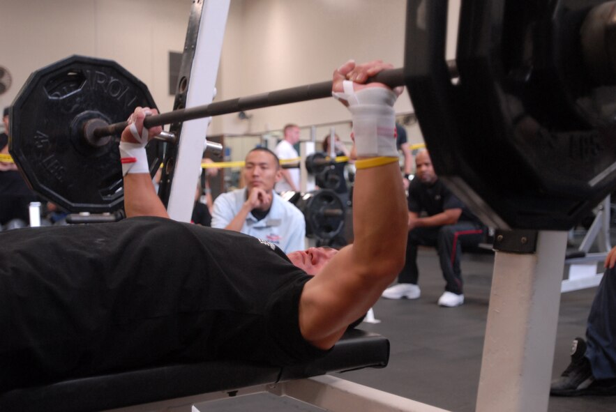 Naoyuki Koga lifts weights during the second round of the 18th Services Squadron-sponsored bench press competition here. Mr. Haruhiko Ikehara, Okinawa City Office park maintenance, dominated the men’s competition by bench pressing 310 pounds.
(U.S. Air Force/Staff Sgt. Darnell Cannady)