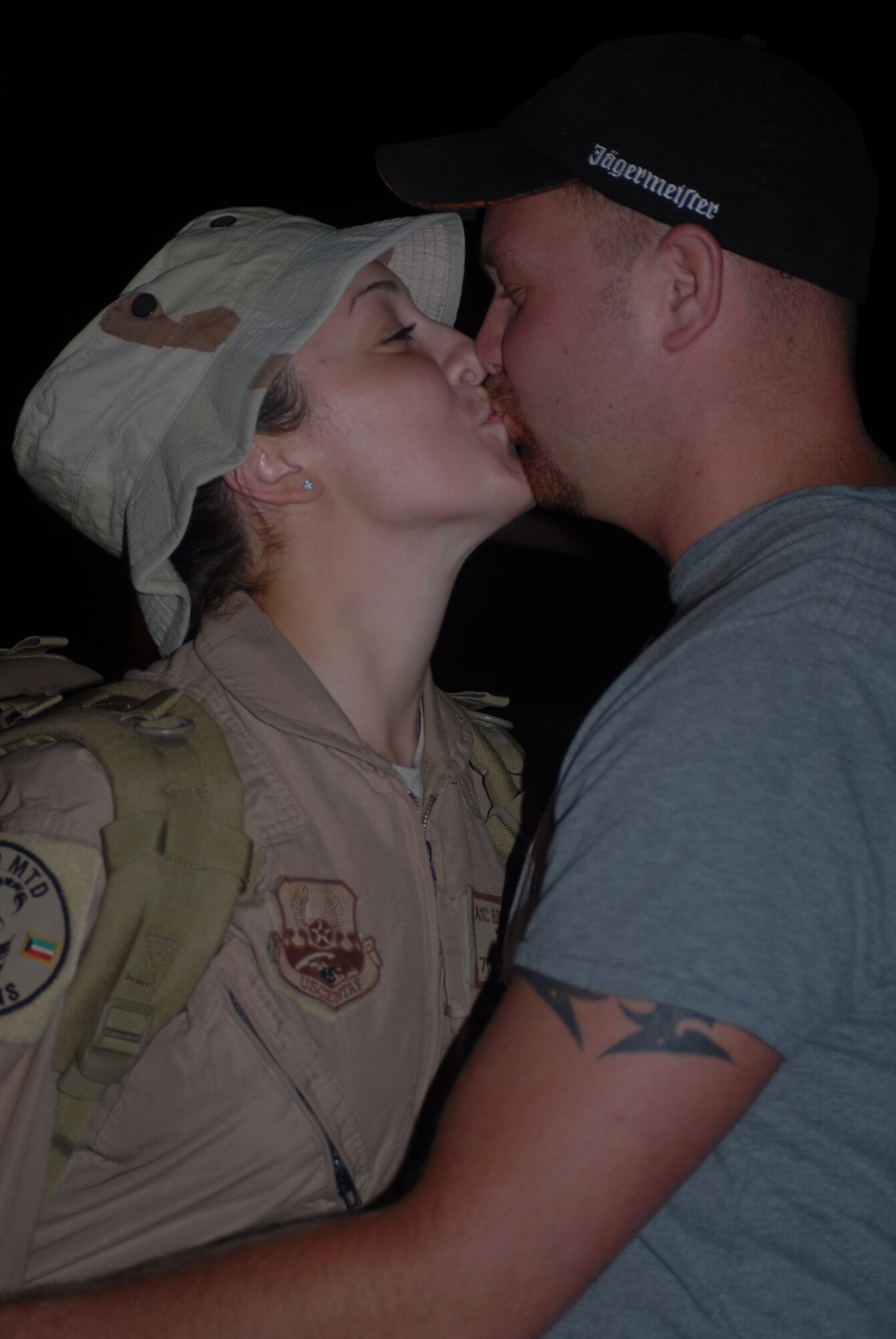 Airman 1st Class Brittany Goff, 43rd Logistics Readiness Squadron, kisses her husband Army Sergeant Jimmy Goff, upon arrival back to Pope after eight months away. (U.S. Air Force Photo by Airman 1st Class Mindy Bloem)