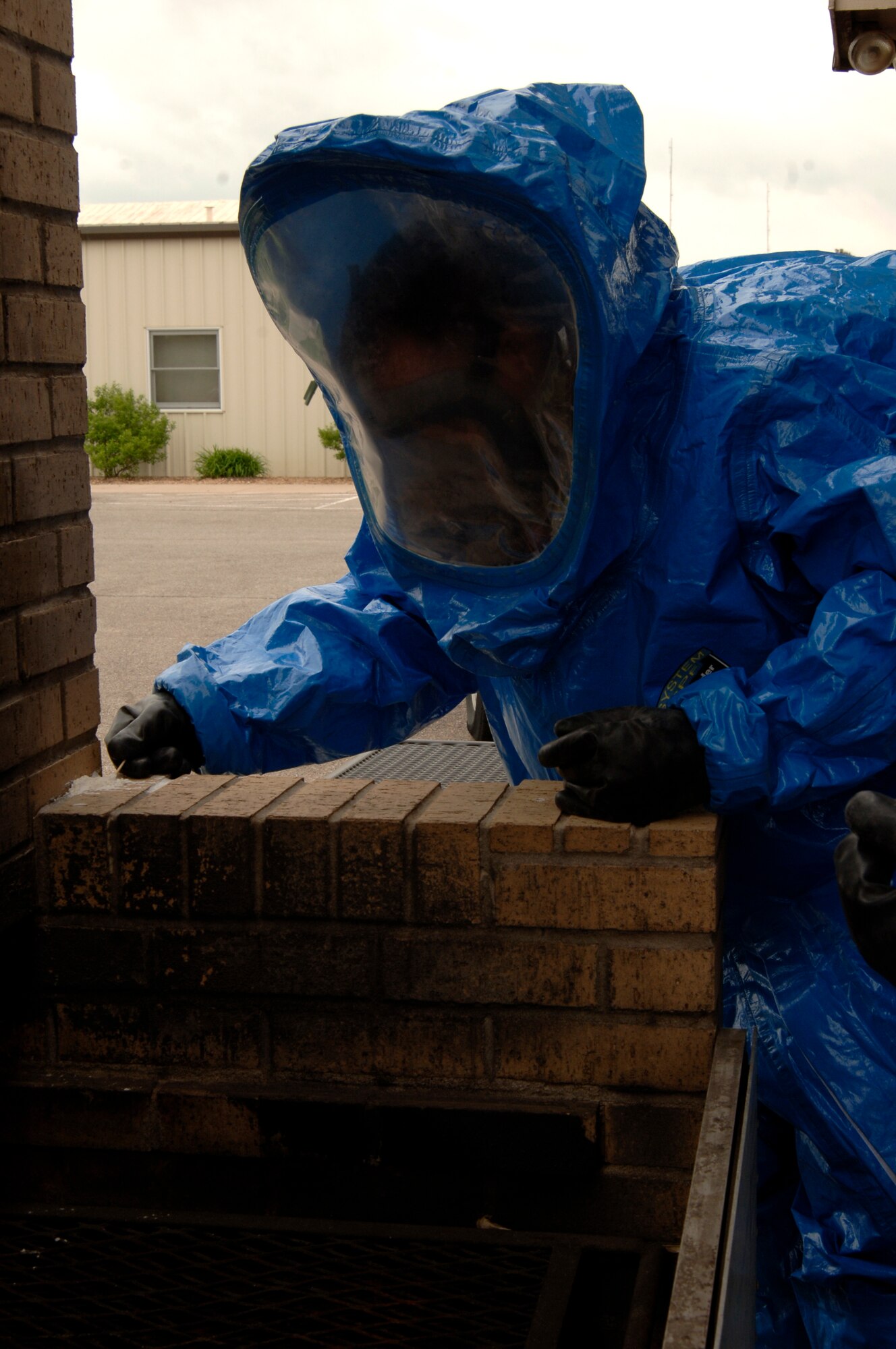 MCCONNELL AIR FORCE BASE, Kan. -- Airman 1st Class Randy Golleher, 22nd Civil Engineering Squadron, Readiness and Emergency Management Flight, collects a sample of a chemical substance for testing during a fake chemical attack, May 13. The Readiness and Emergency Management Flight is in charge of the Mobile Emergency Operations Center which goes to possible sources or points of contamination in order to determine the overall danger caused by a chemical attack. (Photo by Airman Justin Shelton)