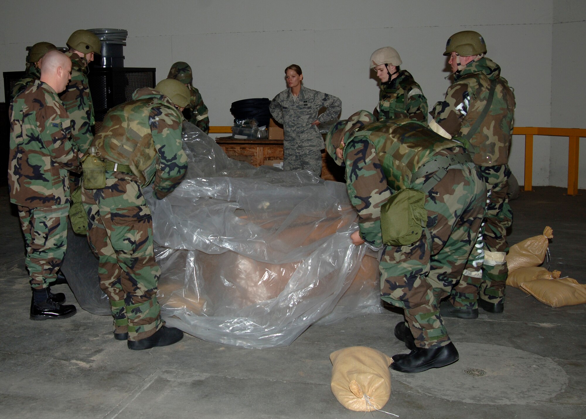 MCCONNELL AIR FORCE BASE, Kan. -- The 22nd Civil Engineering  Squadron, Chemical, Biological, Radiological, Nuclear, and Explosive class practices securing a stationary asset in order to prevent  possible contamination, May 13. The 22nd CES contains a readiness flight that is responsible for ensuring that the entire wing is prepared for a CBRNE attack in both wartime and peacetime missions. (Photo by Airman Justin Shelton)