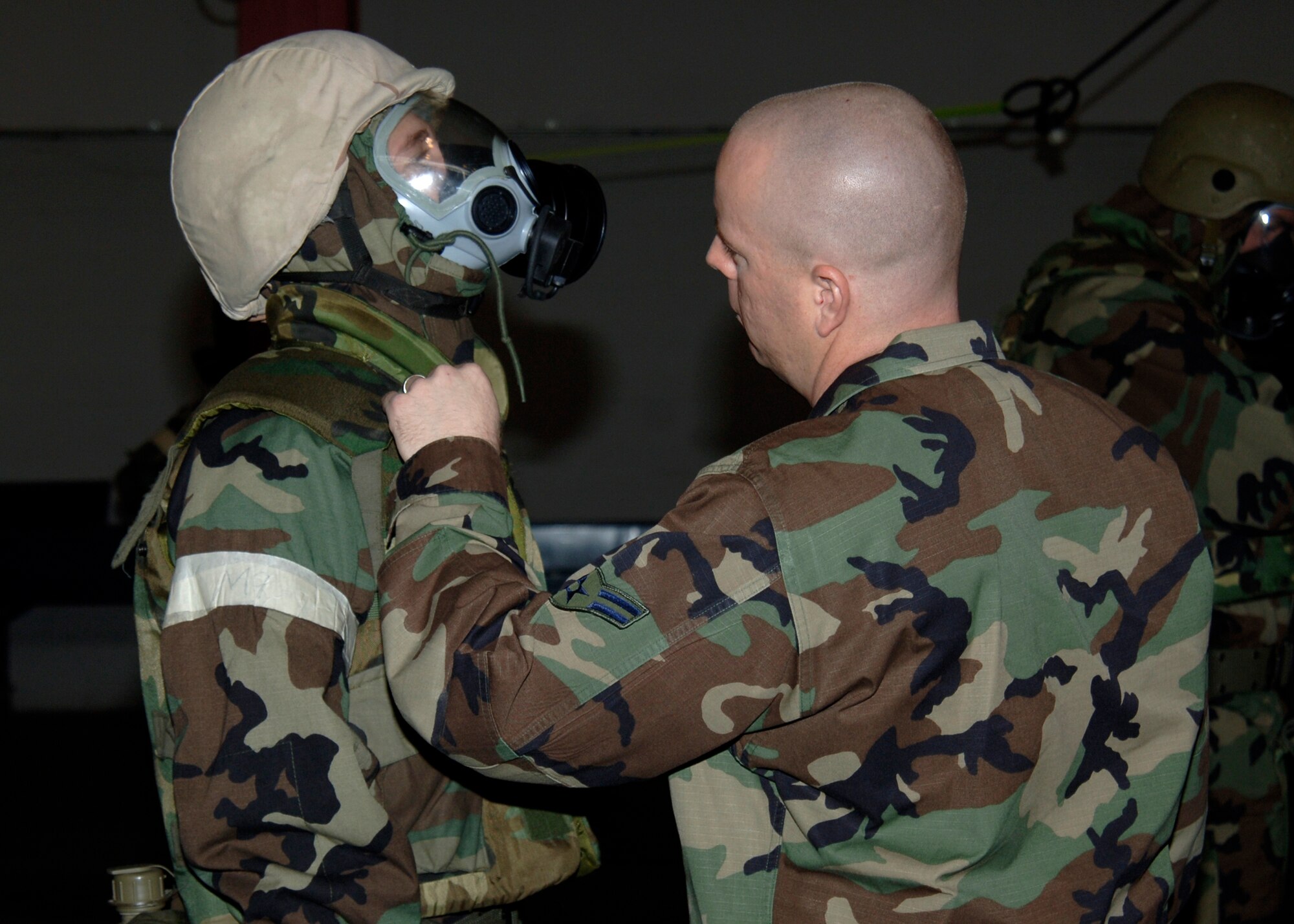 MCCONNELL AIR FORCE BASE, Kan. -- Airman 1st Class Arval Hawkins, 22nd Civil Engineering Squadron, checks Airman 1st Class Brandon Goode’s equipment during Chemical, Biological, Radiological, Nuclear, and Explosive training, May 13. Airman Hawkins is a CBRNE instructor and helps reeducate McConnell personnel on how to properly wear mission oriented protective posture gear. (Photo by Airman Justin Shelton)