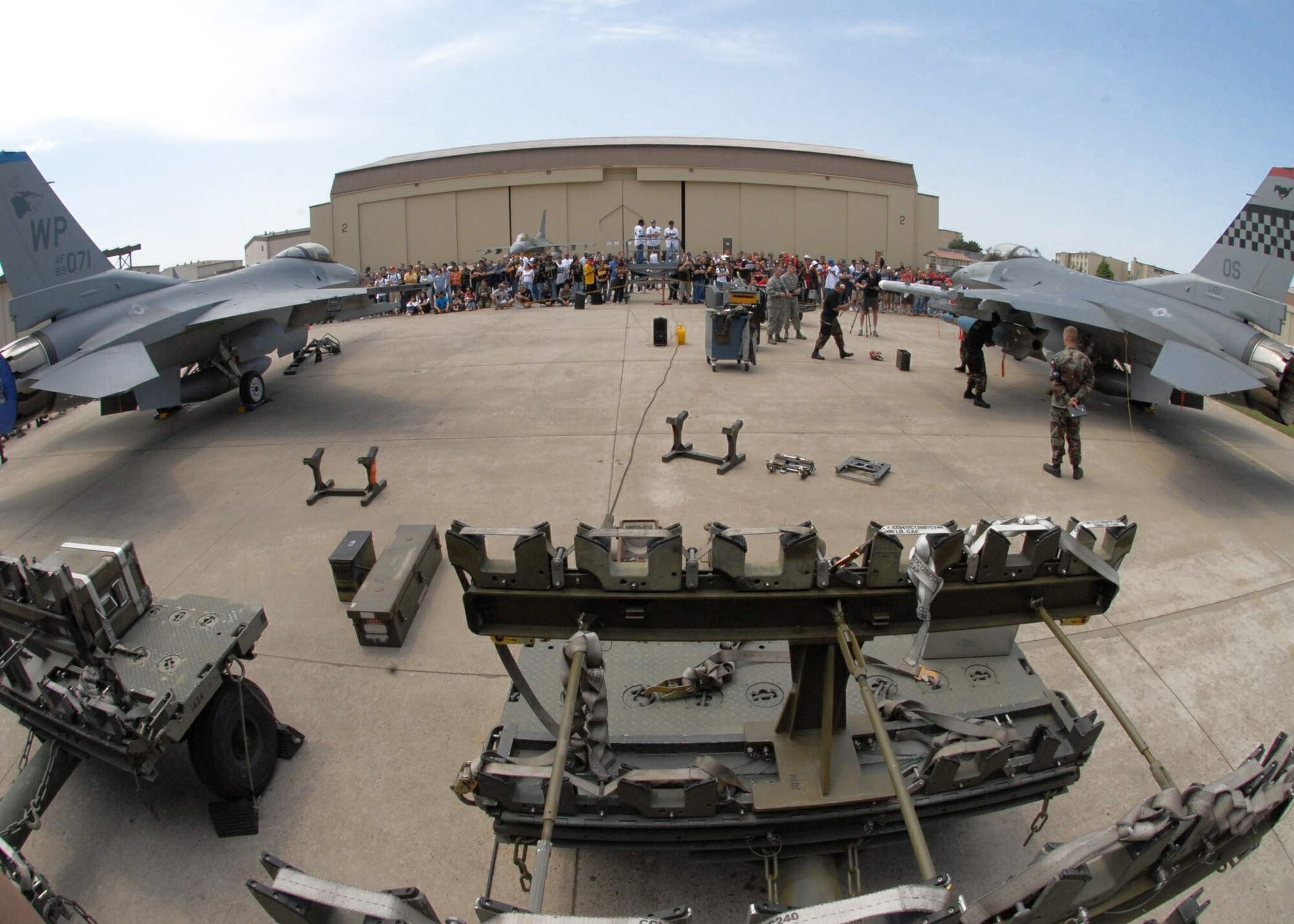 Members from the 35th Aircraft Maintenance Unit from Kunsan Air Base, South Korea, and the 36th Aircraft Maintenance Unit from Osan AB, South Korea, compete against each other during a peninsula-wide weapons load competition May 10 at Kunsan AB. (U.S. Air Force photo/Staff Sgt. Araceli Alarcon) 
