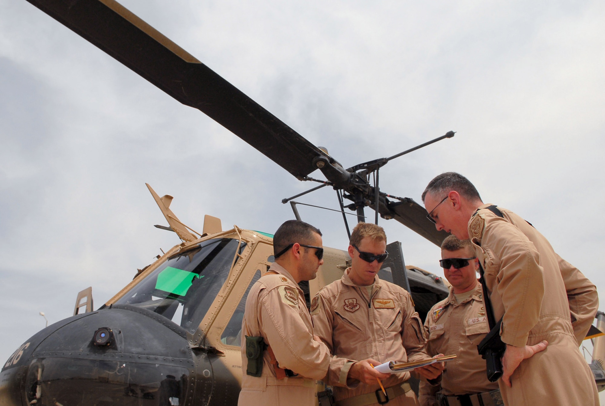 Pilots and flight medics discuss an Iraqi air force medical evacuation mission flown May 14 from the Air Force Theater Hospital at Balad Air Base, Iraq, to the U.S. Army's 86th Combat Support Hospital in Baghdad. (U.S. Air Force photo/Senior Airman Julianne Showalter)
