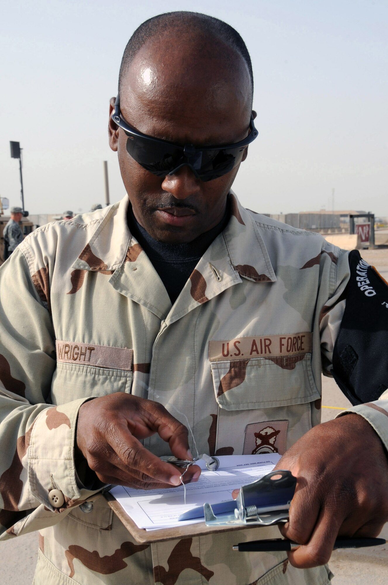 Tech. Sgt. Paul Wright reviews the customs inspection form at Ali Base, Iraq, for the U.S. Army 600th Transportation Company before the company heads home. The Airmen search for contraband items, such as war trophies, and living creatures trying to hitch a free ride back to the United States. Sergeant Wright is a 407th Provost Marshal's office military police Airman, and is deployed from Spangdahlem AB, Germany. (U.S. Air Force photo /Tech. Sgt. Sabrina Johnson) 