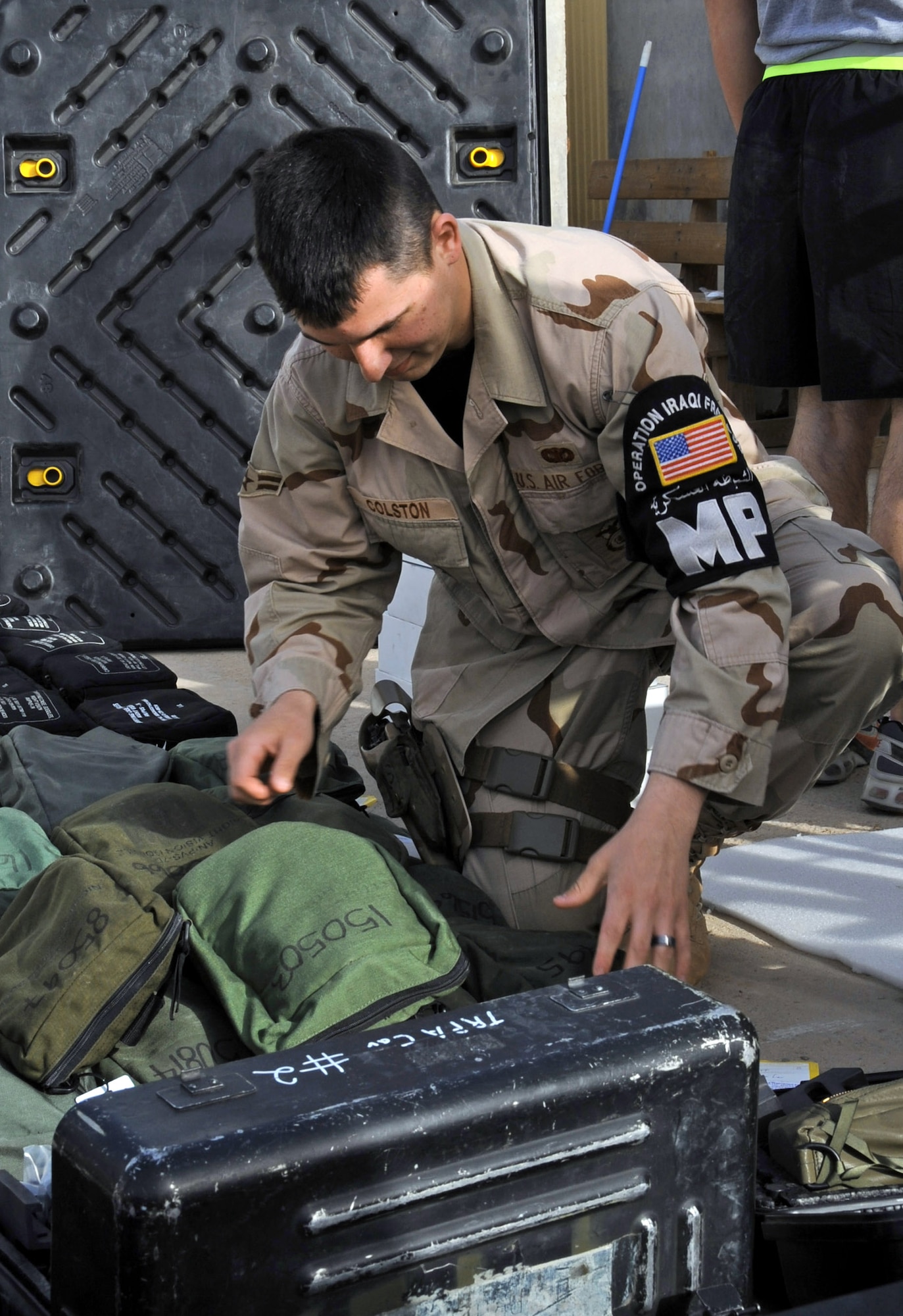 Airman 1st Class Cody Colston inspects cargo at Ali Base, Iraq, before it leaves for the United States. The Provost Marshal's office inspects the cargo of more than 10,000 incoming and outgoing personnel to help prevent the contamination of foreign life in native ecosystems. Airman Colston is a 407th Provost Marshal's office military police Airman, and is deployed from Royal Air Force Lakenheath, England. (U.S. Air Force photo /Tech. Sgt. Sabrina Johnson) 