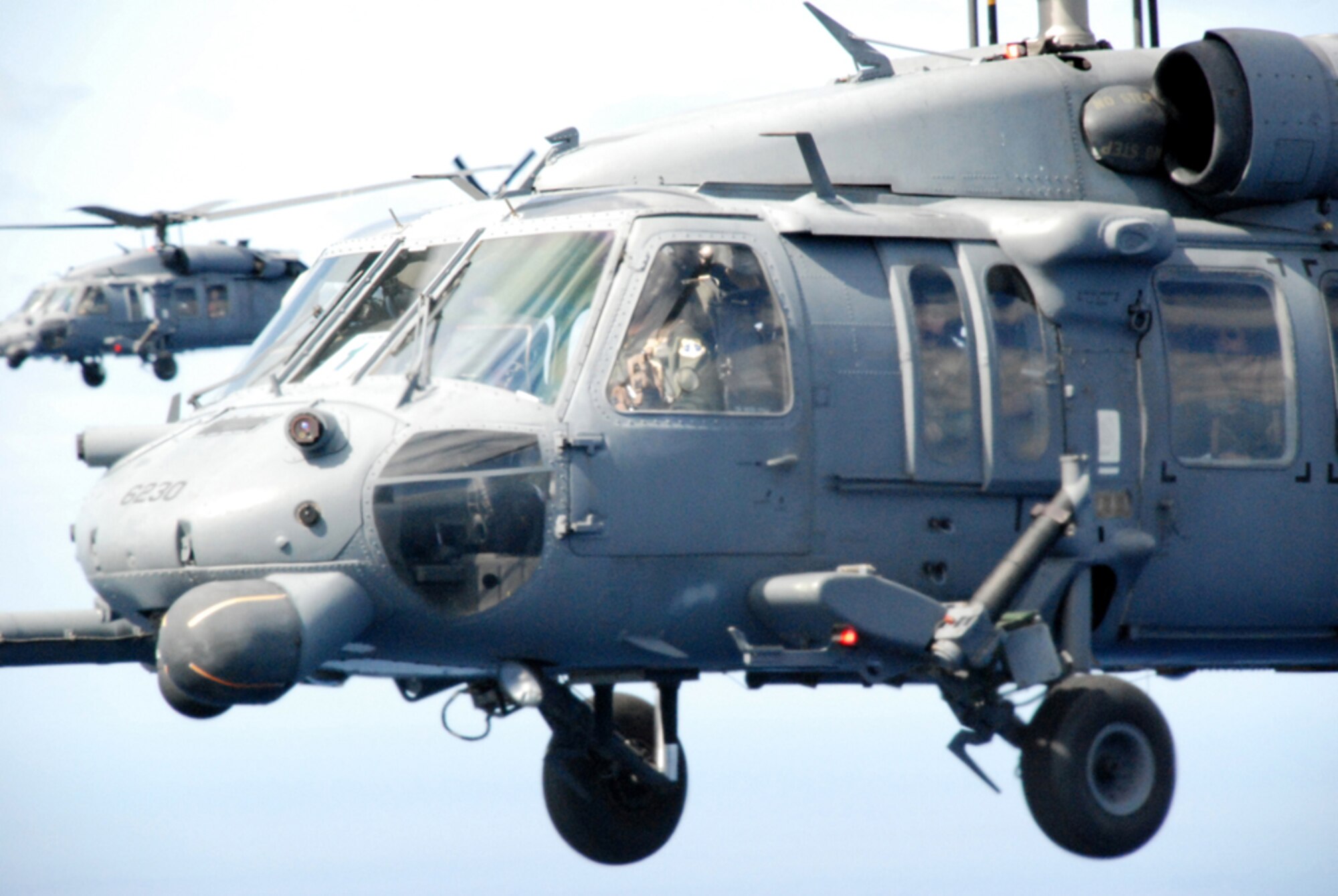 PATRICK AIR FORCE BASE, Fla. -- Two HH-60G Pave Hawk helicopters fly in formation during a recent Space Shuttle search and rescue exercise of the Florida coast.  The two helicopters are from the 920th Rescue Wing at Patrick AFB.  Pararescuemen and crews from the 920th RQW are part of a joint task force that supports every Space Shuttle launch and are ready in the event of an emergency.  (U.S. Air Force photo/Capt. Cathleen Snow) 