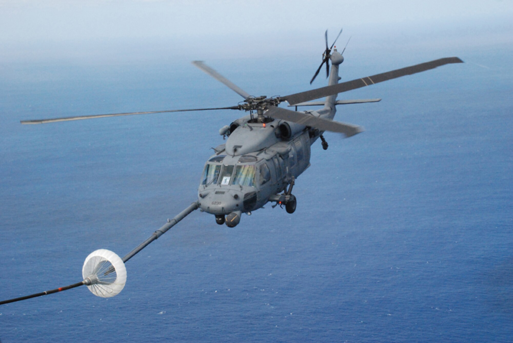 PATRICK AIR FORCE BASE, Fla. -- A HH-60G Pave Hawk helicopter from the 920th Rescue Wing hooks up to the drogue on a HC-130P/N aircraft during mid-air refueling operations.  Both aircraft were participating in a Mode 8 astronaut bailout search and rescue exercise. Air Force active duty, guard, and reserve units, along with Navy, Coast Guard and National Aeronautics Space Administration organizations, participated in the exercise which was held off the Florida coast.  (U.S. Air Force photo/Capt. Cathleen Snow)