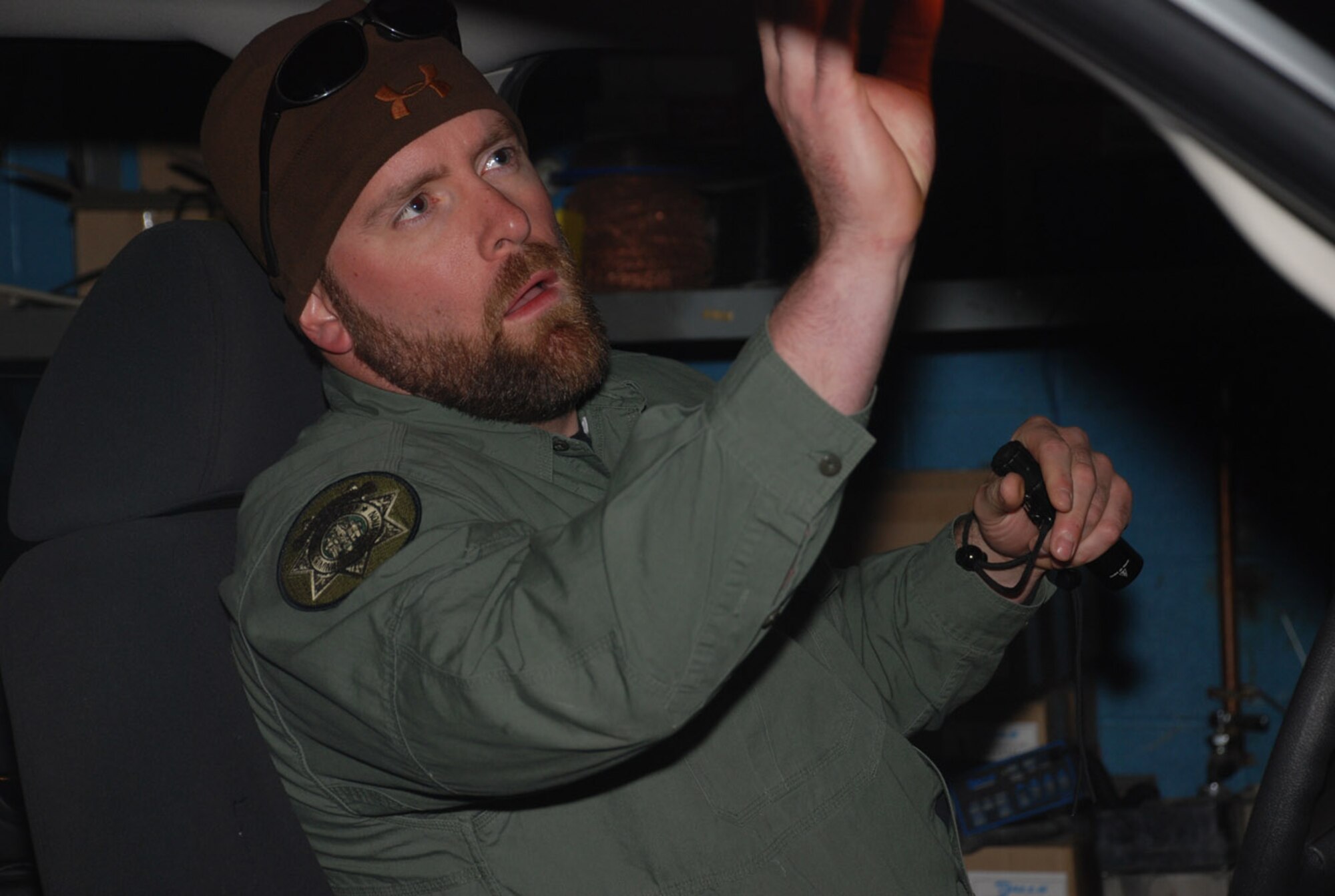 Jason Moon, Wyoming Department of Criminal Investigation, searches a vehicle for weapons and contraband during the search challenge of the competition. Mock illegal objects were hidden throughout the vehicle, and the teams were timed on how long it took to find them.