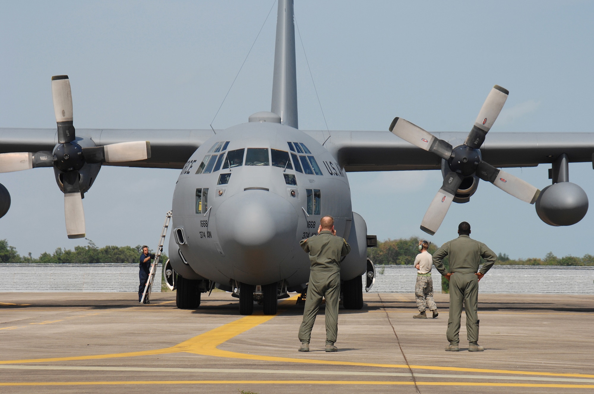UTAPAO, Thailand - Airmen from Yokota Air Base, Japan prepare to service a C-130 Hercules after its delivery of U.S. humanitarian relief supplies to the people of Burma May 14. The Airmen are deployed in support of Operation Caring Response. (USAF photo by Senior Airman Sonya Croston)