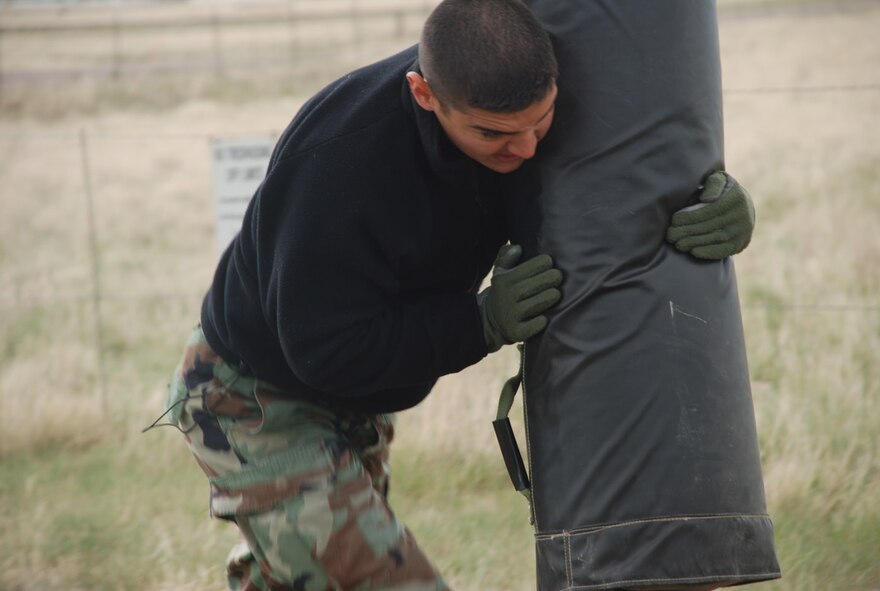 Airman Richardson pushes a tackle sled during the obstacle portion of the Armed Forces Challenge Wednesday. Airman Richardson was a member of team Ramrod.