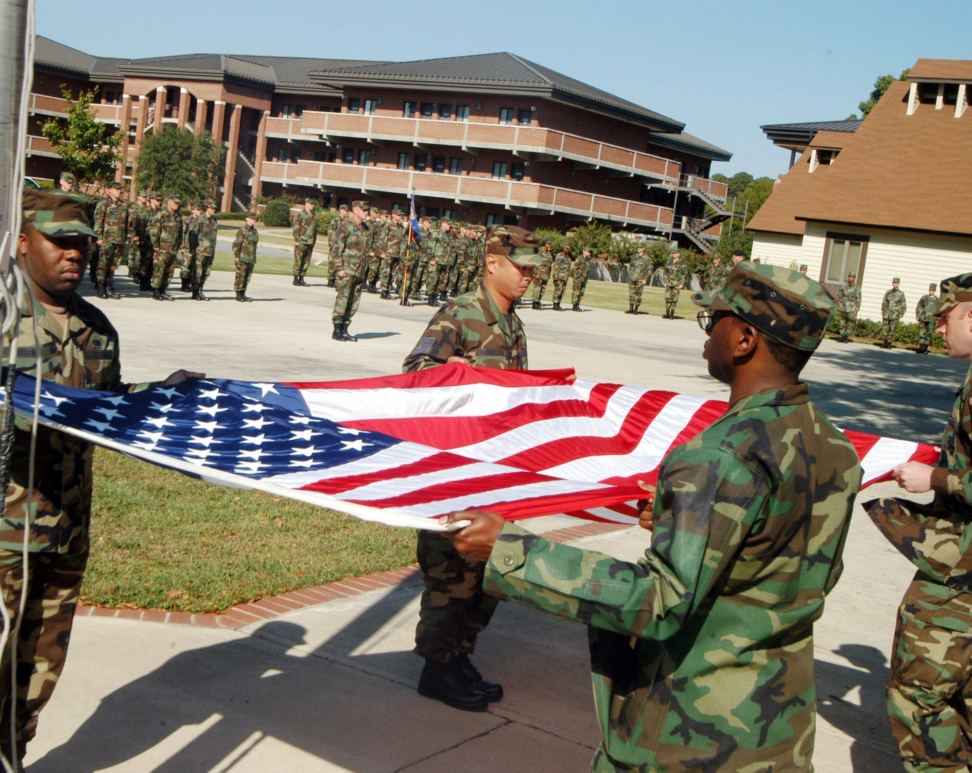 TSgts.  Anthony Allen,  Sr. and Phil Evangelista, Damien Tymes and Christopher Mitchell, retire the colors after the retreat ceremony for the NCOA 50th  anniversary. U. S. Air Force photo by Sue Sapp 