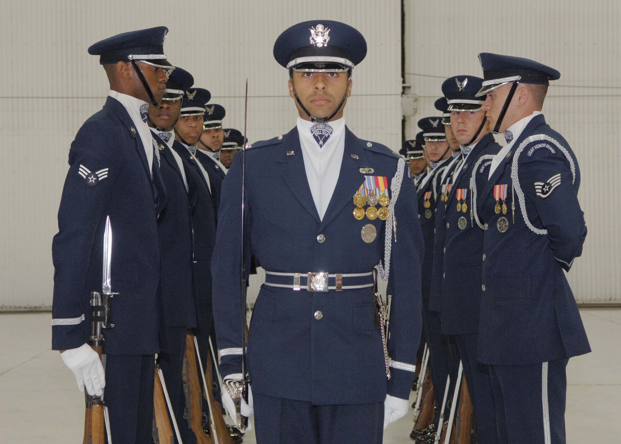 GRAN D FORKS AIR FORCE BASE, ND – Capt. Josh Hawkins, commander of the drill team flight, stands proudly in front of the Air Force Honor Guard drill team during a performance in a hangar here May 7. The drill team stopped and demonstrated their precision and professionalism for the Warriors of the North as well as base youth as they travel through the Mid-West. (U.S. Air Force photo/Senior Airman Tiffany Colburn)