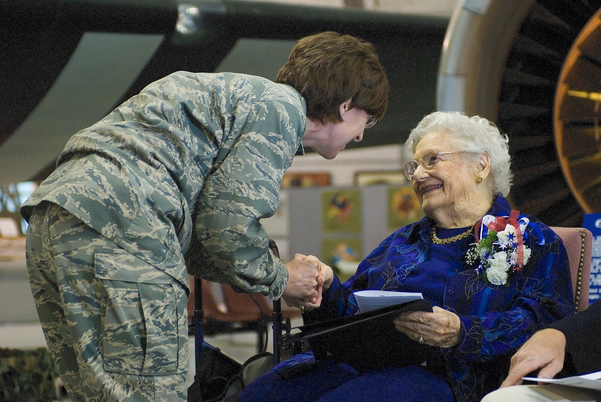 Lt. Col. Marcia Potter, 436th Medical Group chief nurse, presents Dorothy Lewis with the Nurse’s coin of the U.S. Air Force during the ceremony May 9 at the Air Mobility Command Museum. (U.S. Air Force photo/Roland Balik)