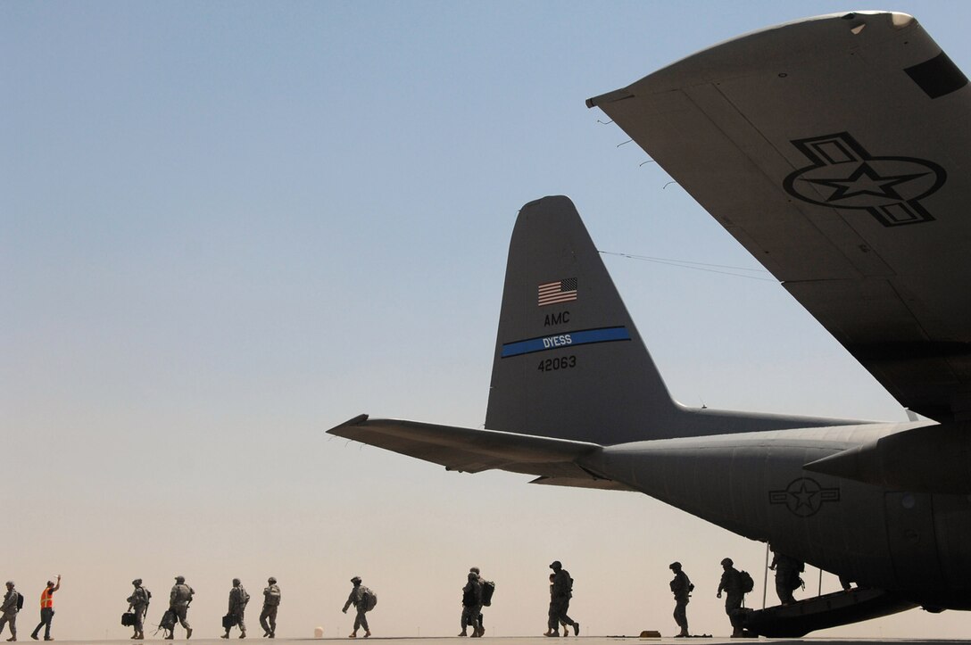 Servicemembers exit a C-130 Hercules May 10 at Balad Air Base, Iraq. The aircraft has saved lives by keeping convoy vehicles off dangerous Iraqi roads. (U.S. Air Force photo/Senior Airman Julianne Showalter) 