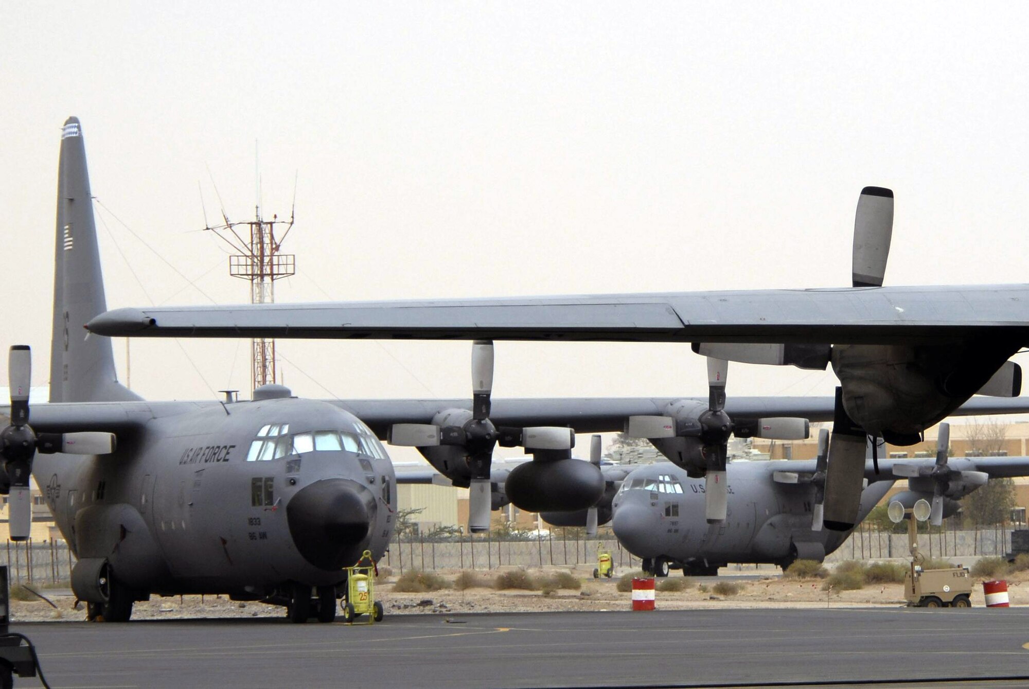 C-130 Hercules aircraft wait for an airlift mission at a Southwest Asia location. These C-130s transport coalition forces and equipment in support of operations Enduring Freedom and Iraqi Freedom (U.S. Air Force photo/Staff Sgt. Patrick Dixon)
