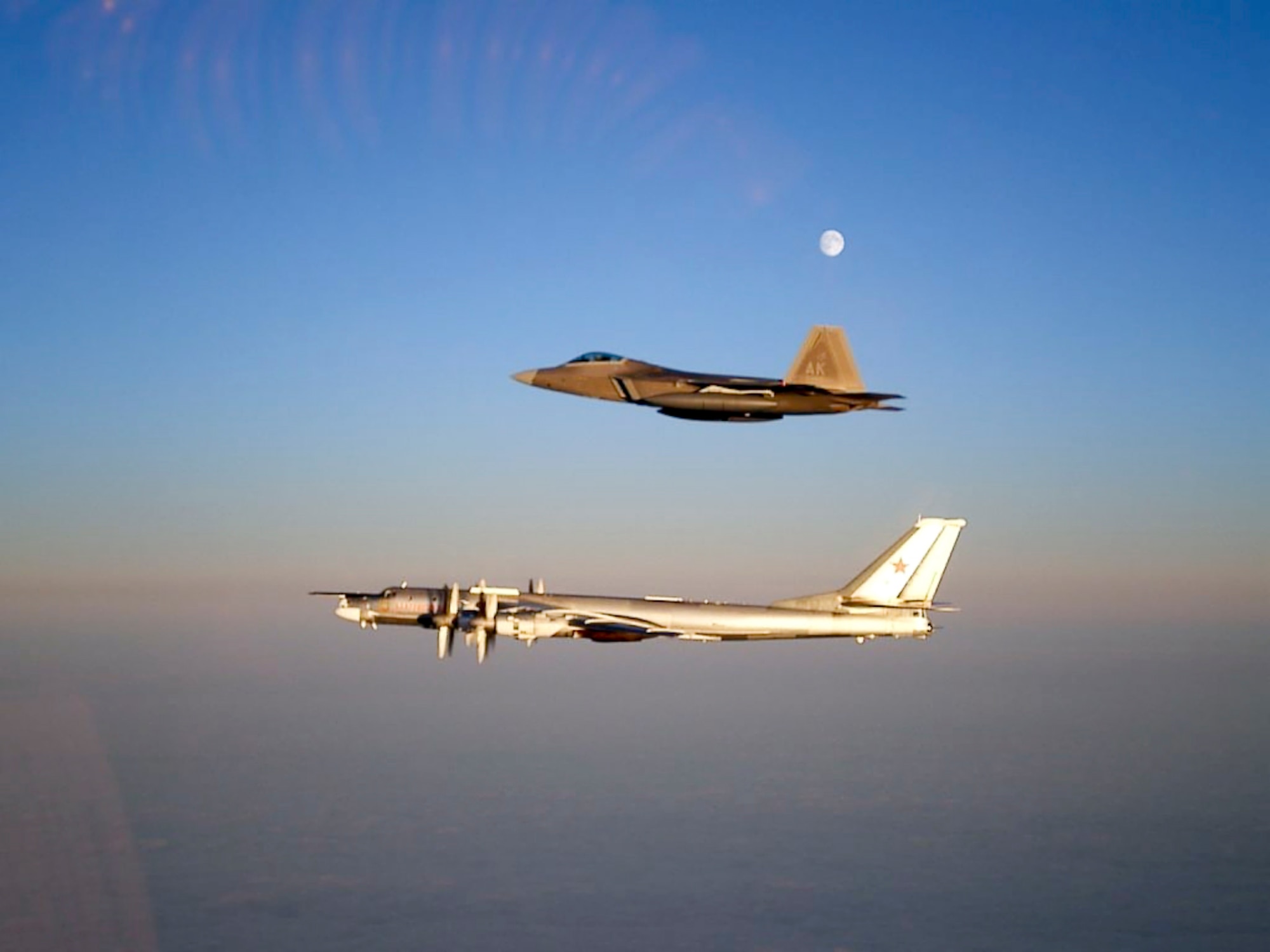 A 90th Fighter Squadron F-22A Raptor escorts a Russian TU-95 Bear flying near the Alaskan NORAD Region airspace Nov. 22, 2007. This marked the first time a Raptor was called upon to support the ANR mission. (U.S. Air Force photo)