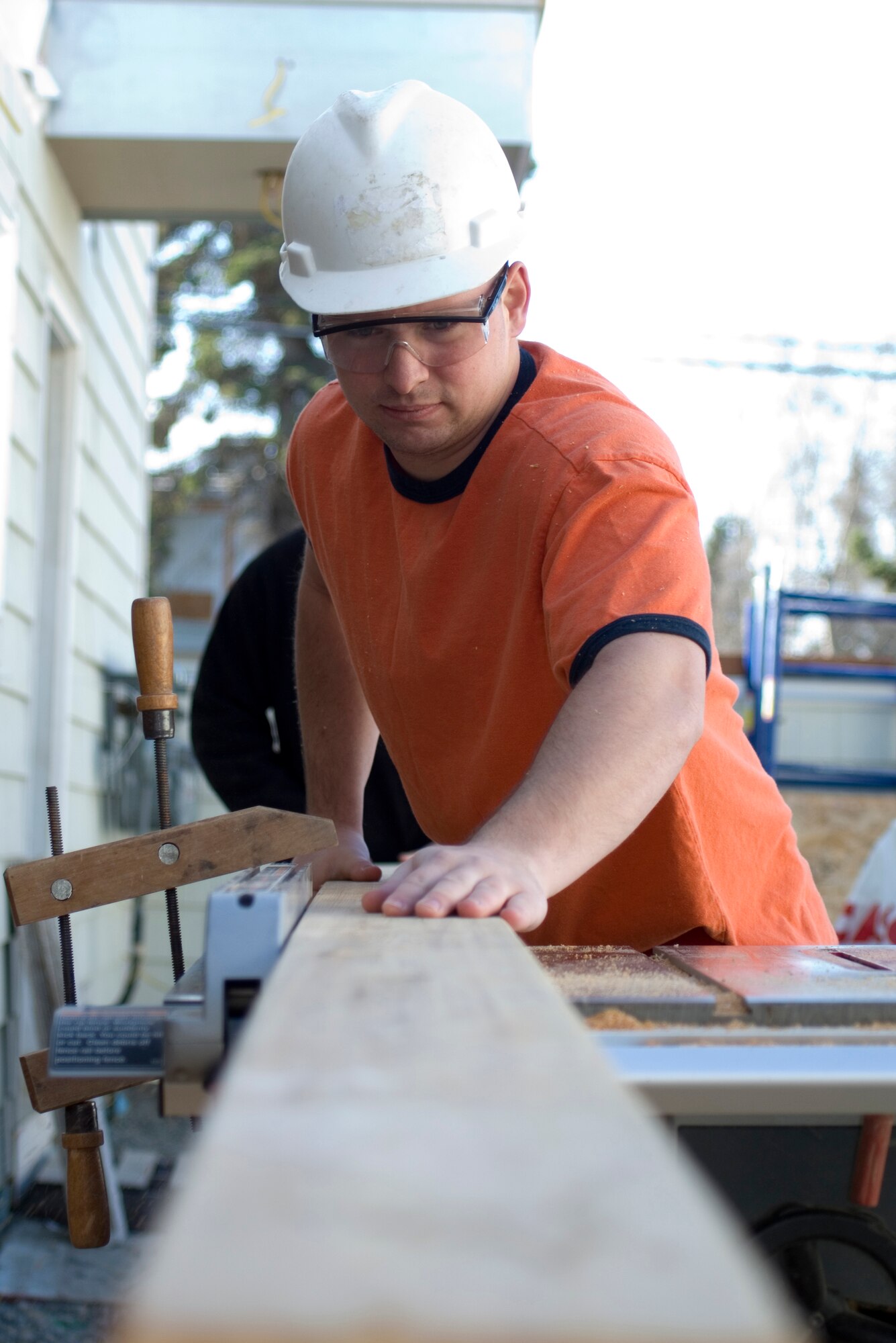Staff Sgt. Michael McClary pushes a 2X6 through a table saw. Sergeant McClary is the First Term Airmen Center flight chief and a member of the 3rd Civil Engineer Squadron Structures Section. (U.S. Air Force photo by Airman 1st Class David Carbajal)