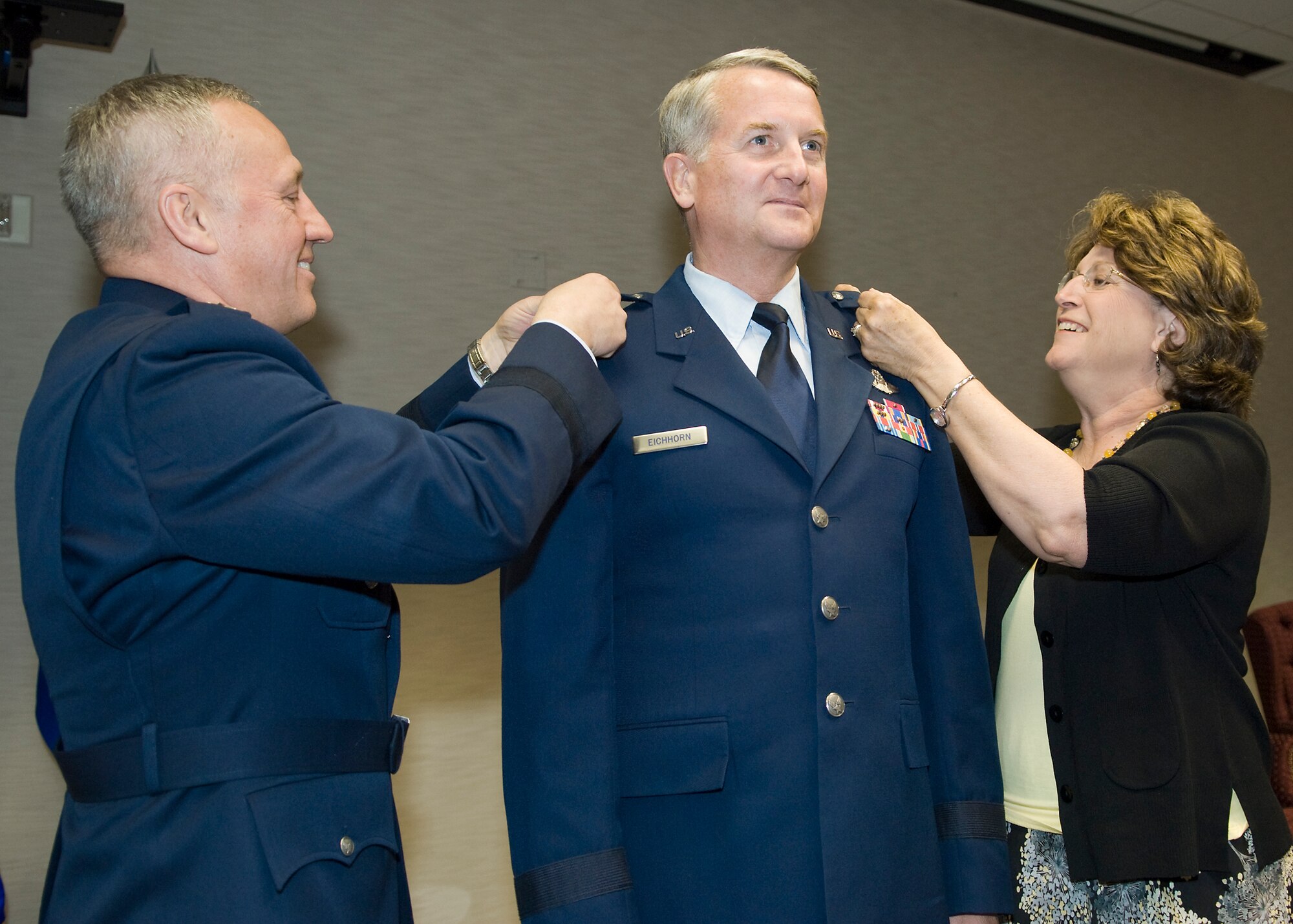 Maj. Gen. David Eichhorn (center), Air Force Flight Test Center commander, gets his second star pinned on from his wife, Anita Eichhorn (right), and Gen. Bruce Carlson, Air Force Materiel Command commander, during General Eichhorn's promotion ceremony at the Conference Center here May 14. As the AFFTC commander, General Eichhorn is responsible for executing test and evaluation programs for the Department of Defense, the Defense Advanced Research Project Agency and the National Aeronautics and Space Administration. (Air Force photo by Mike Cassidy)
