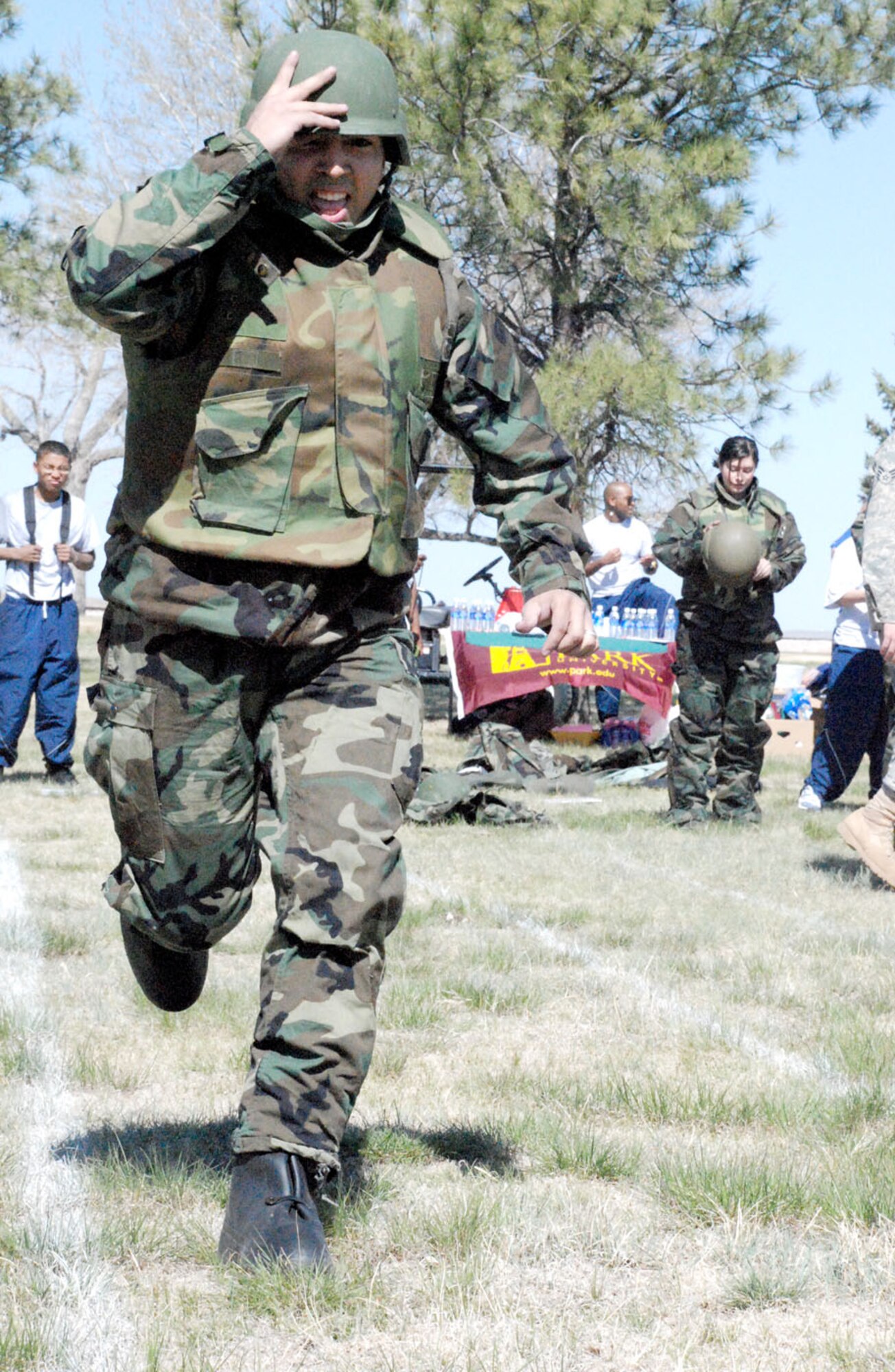 Airman 1st Class Jesse Castaneda, 90th Force Support Squadron representative, runs toward the halfway point of the MOPP 2 relay Tuesday before the wing run. Airman Castaneda finished the 100 yard run in 2 minutes and 50 seconds. The donning and removing of the protective gear was included in the race time (Photo by Airman 1st Class Daryl Knee). 