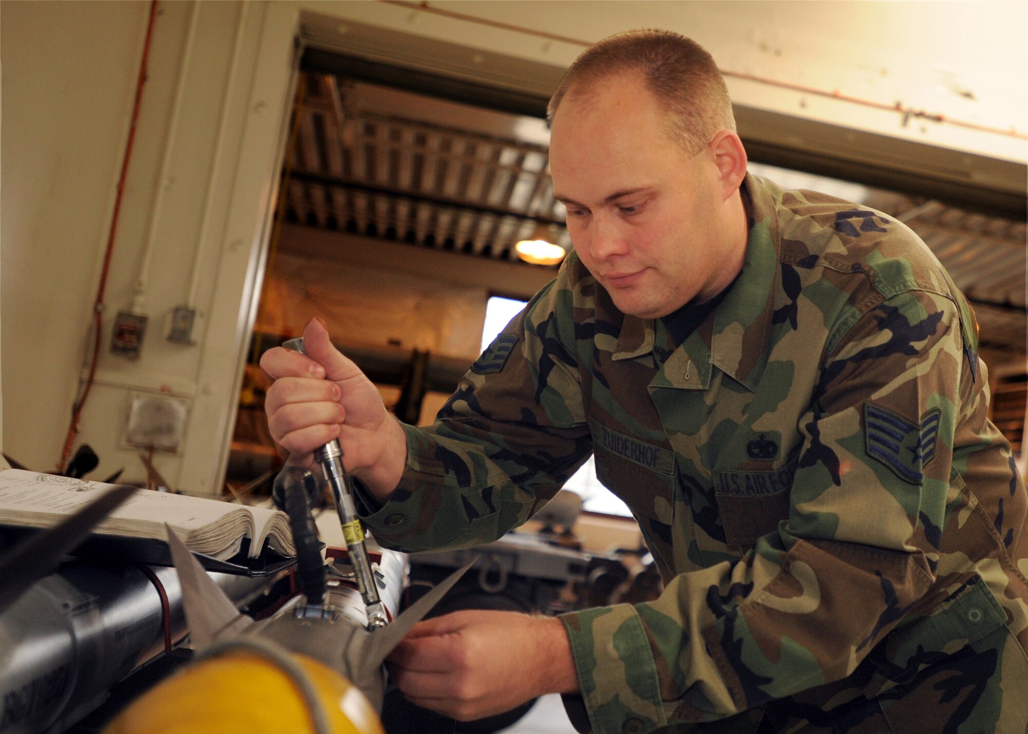 Staff Sgt. Wayne Zuiderhof, 3rd Equipment Maintenance Squadron Munitions Flight, torques the wing assembly of a weapon body May 14. Sergeant Zuiderhof was one of two recipients of the 2007 AIM-9X Cutting Edge Award. (U.S. Air Force photo by Airman 1st Class Laura Turner)