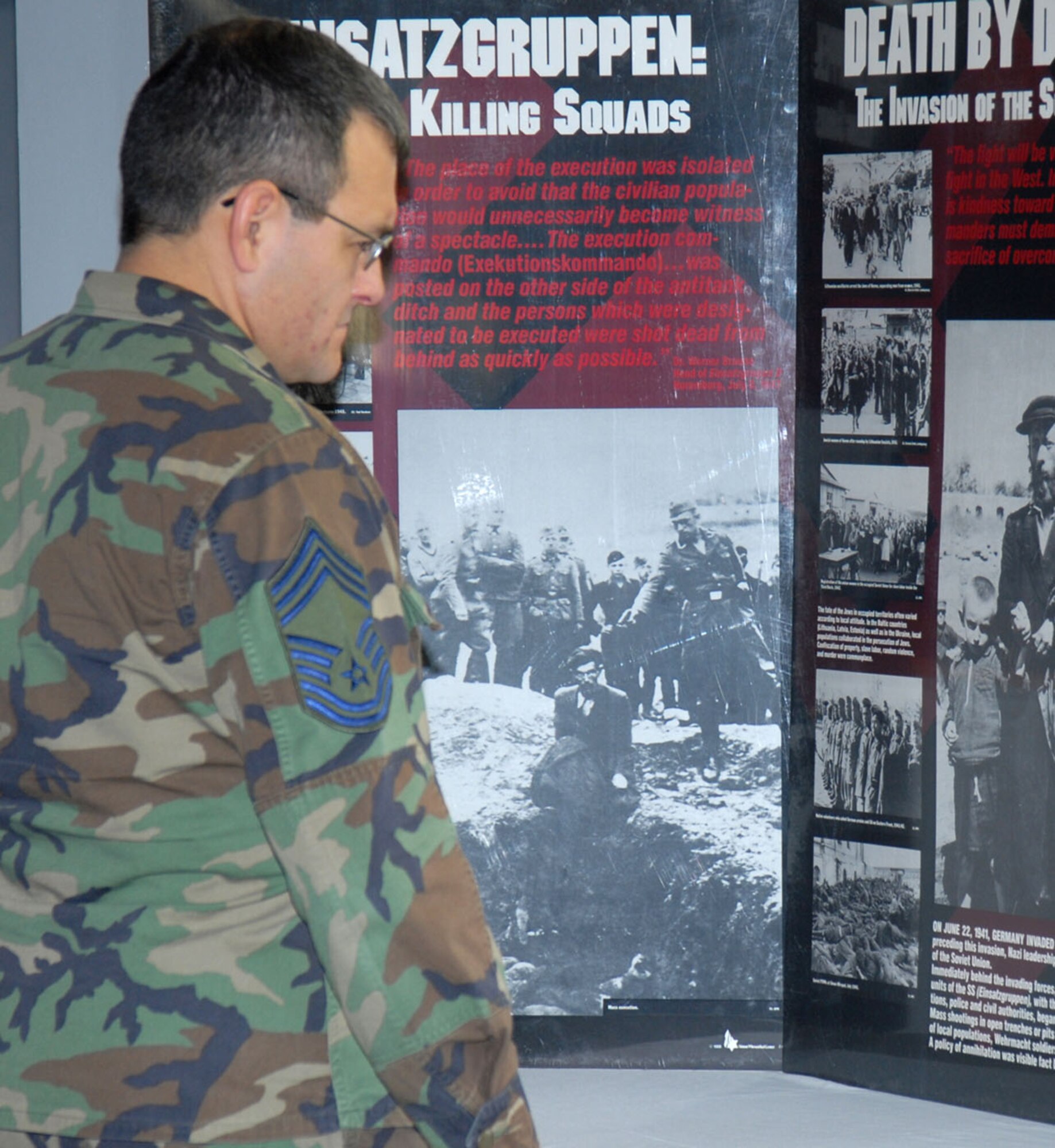 Chief Master Sgt. Alfonso Martinez, 90th Mission Support Group superintendent, reads the informative boards during the Holocaust Day of Remembrance event in the Warren Pronghorn Center May 2. The room was lined with boards describing the entire Holocaust era (Photos by Bernie Ernst).