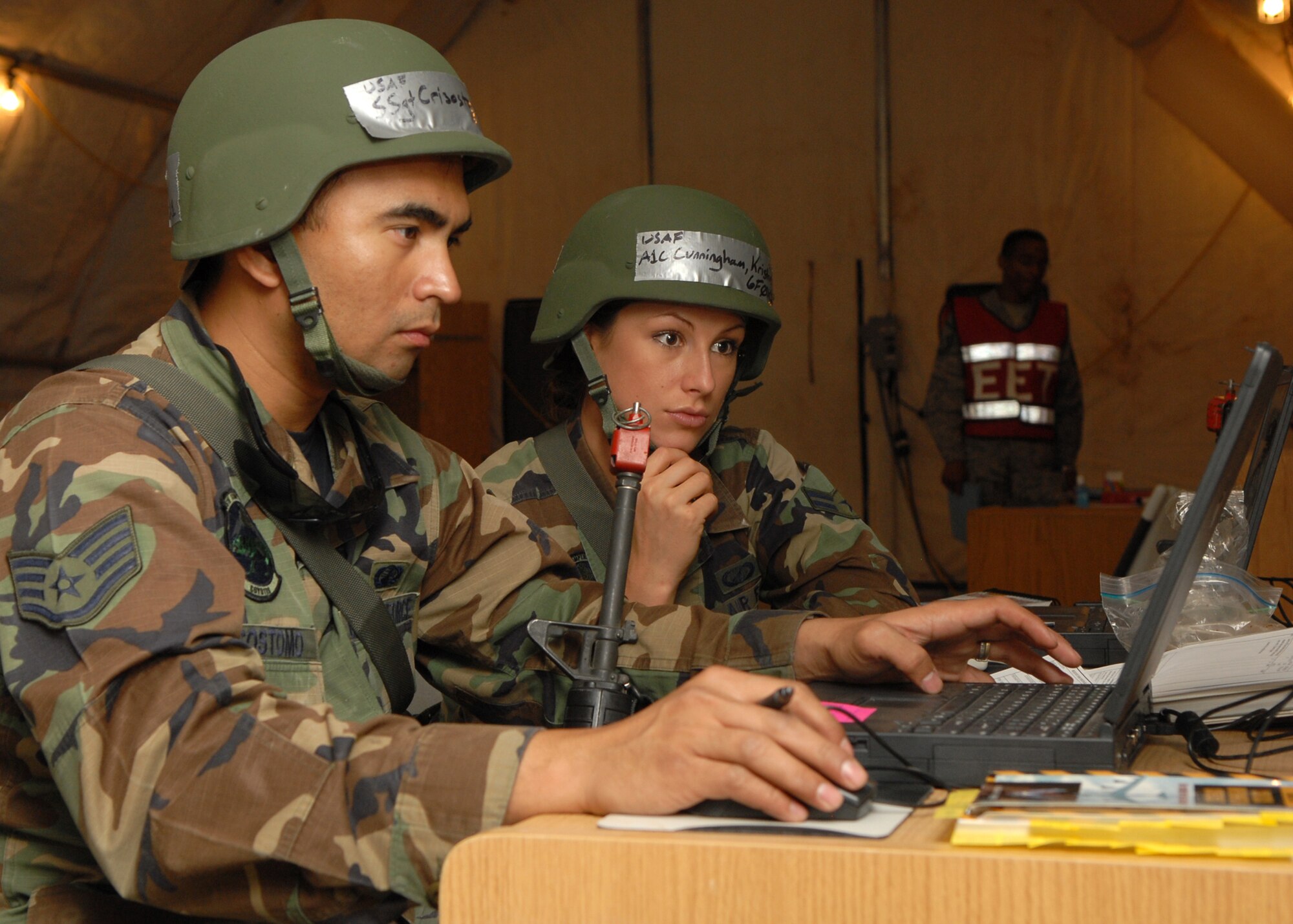 Staff Sergeant Ritche Crisostomo and Airman First Class Kristin Cunningham simulate account procurement for a budget plan during exercise Crown Talon 08-02, May 14, Luke Air Force Base, Ariz.  Sergeant Crisostomo and Airman Cunningham are finance representatives from the 56th Comptroller Squadron. (U.S. Air Force photo/Staff Sergeant Jerry Fleshman)