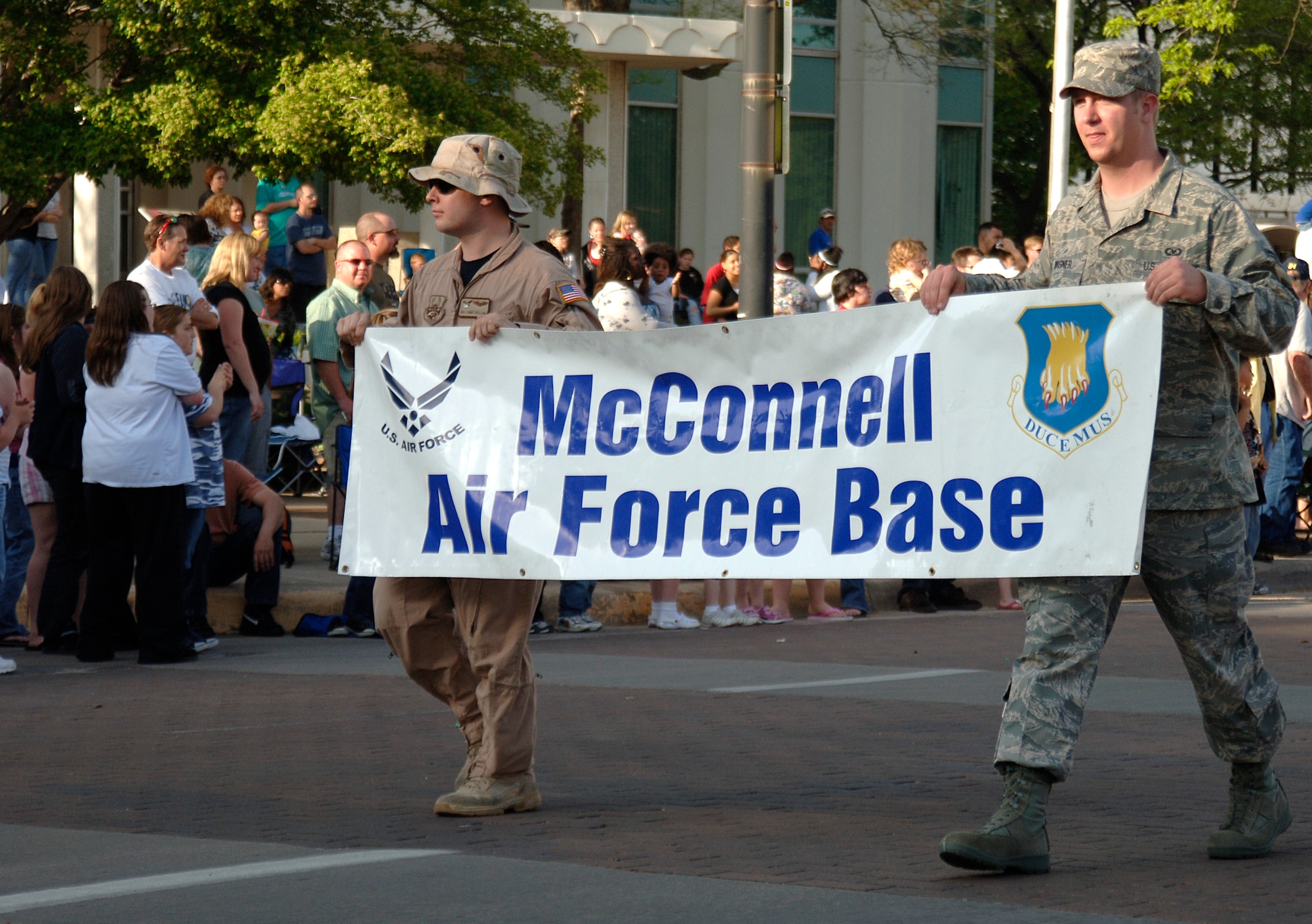 MCCONNELL AIR FORCE BASE, Kan. -- Team McConnell members participate in the Sundown Parade during River Festival in downtown Wichita, May 9.  Team McConnell family members rode on a float while servicemembers walked alongside.  (Photo by Staff Sgt. Ronald Lafosse.)