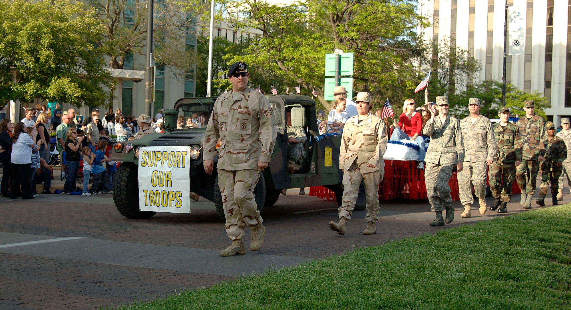 MCCONNELL AIR FORCE BASE, Kan. -- Senior Airman Tommy Holland, 22nd Air Refueling Wing, and Senior Airman Michael Wagner, 350th Air Refueling Squadron, lead Team McConnell members during the Sundown Parade in Wichita, May 9.  (Photo by Staff Sgt. Ronald Lafosse.)