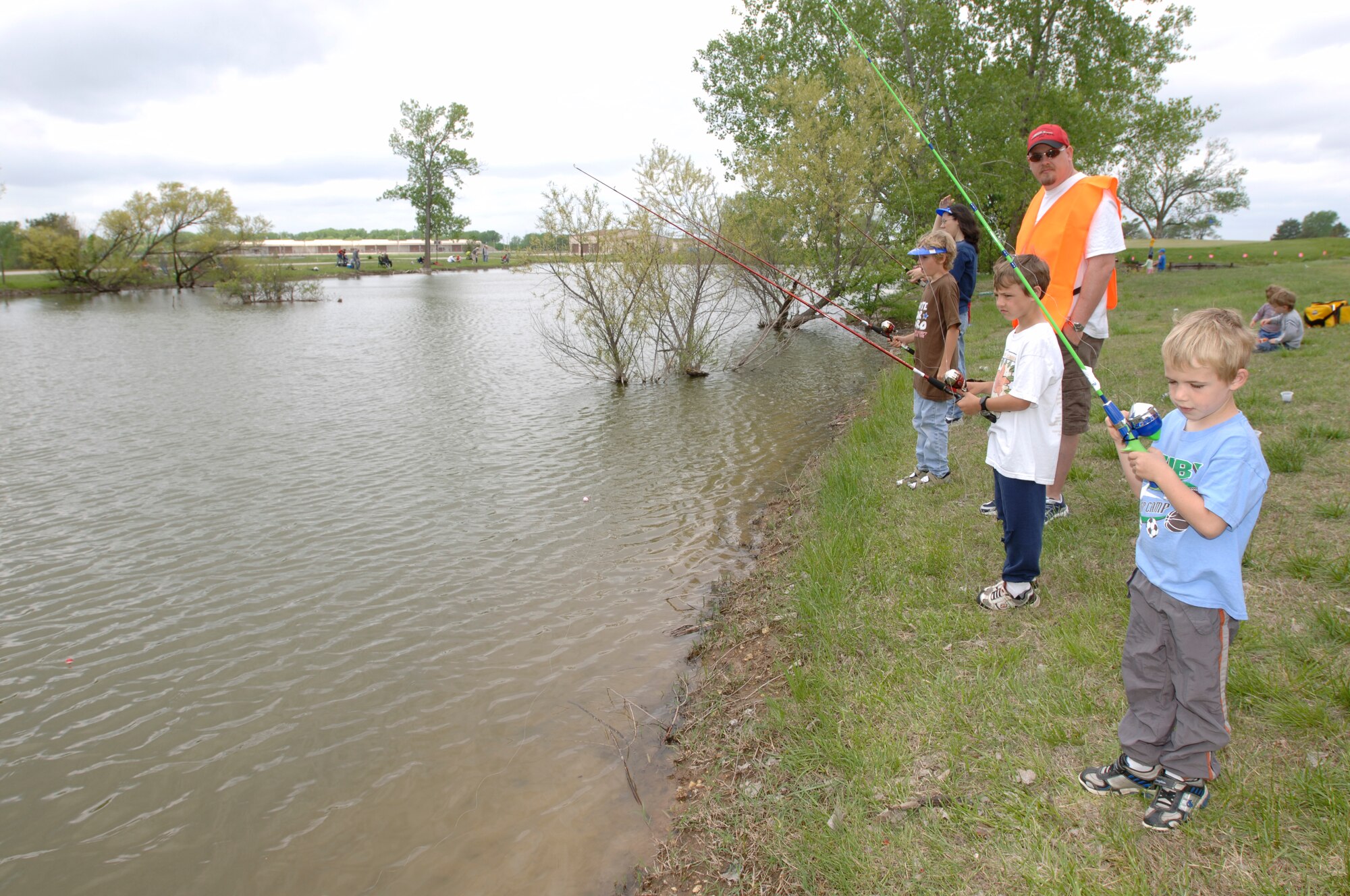 MCCONNELL AIR FORCE BASE, Kan. -- James Harris, 6 (right), Joseph Harris, 8 (middle), Nathaniel, 10 (left), Team of McConnell family member, participate in the annual fishing derby held by 22nd Services Squadron at the Twin Lakes golf course pond, May 10. Out of the 250 Team McConnell members participated, 91 were children. (Photo by Senior Airman Jamie Train)