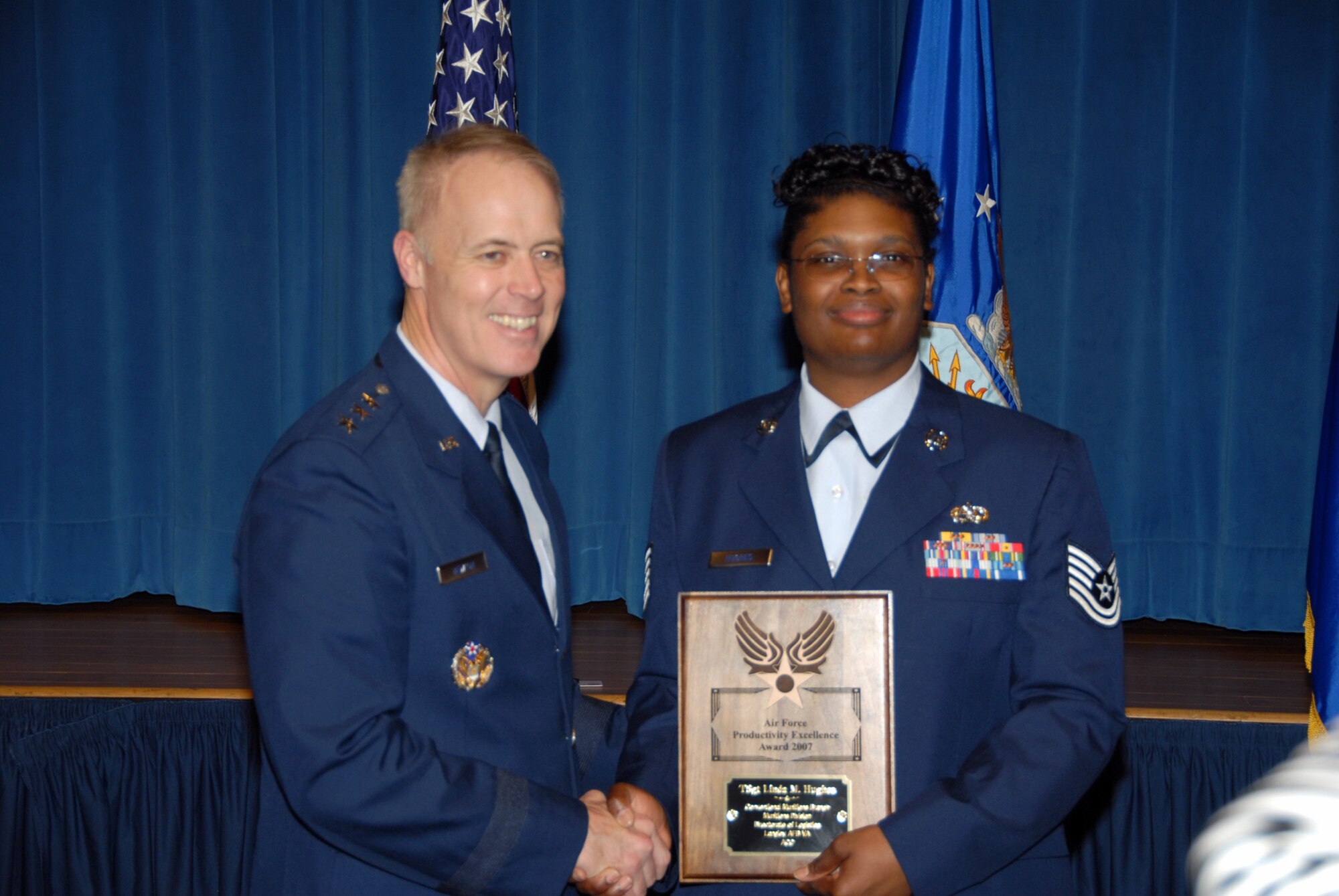 LANGLEY AIR FORCE BASE, Va. -- Lt. Gen. Richard Newton III presents Tech. Sgt. Linda Hughes with the Air Force Productivity Excellence Award at the Pentagon April 8. (Courtesy photo)