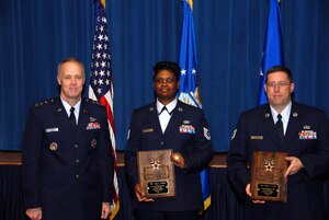 LANGLEY AIR FORCE BASE, Va. -- Lt. Gen. Richard Newton III presents Tech. Sgts. Linda Hughes and Mathew Ferris with the Air Force Productivity Excellence Award at the Pentagon April 8. (Courtesy photo)