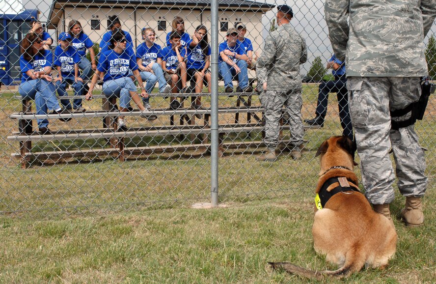 DYESS AIR FORCE BASE, Texas -- Students from O'Brien Middle School listen to Tech. Sgt. Todd Duquette, 7th Security Forces Squadron Kennel Master, as he gives the students a working dog demonstration May 13. (U.S. Air Force photo by Senior Airman Courtney Richardson)