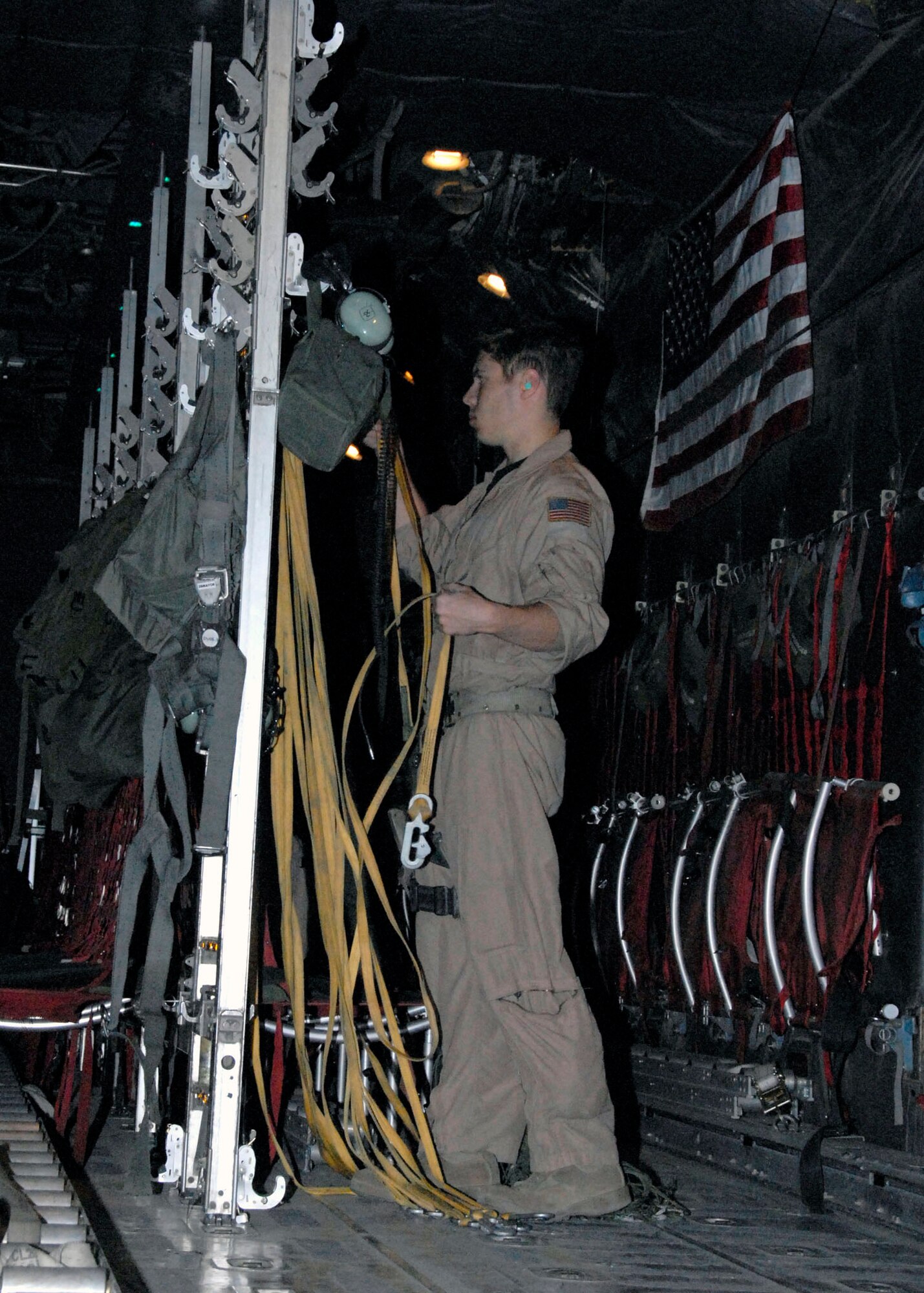 Staff Sgt. Gabriel Molanders puts away the static lines used in airdropping several hundred thousand leaflets from a C-130 Hercules over an Iraqi city recently. Sergeant Molanders is a C-130 loadmaster assigned to the 737th Expeditionary Airlift Squadron and deployed from Dyess Air Force Base, Texas. (U.S. Air Force photo/Tech. Sgt. Michael O'Connor) 
