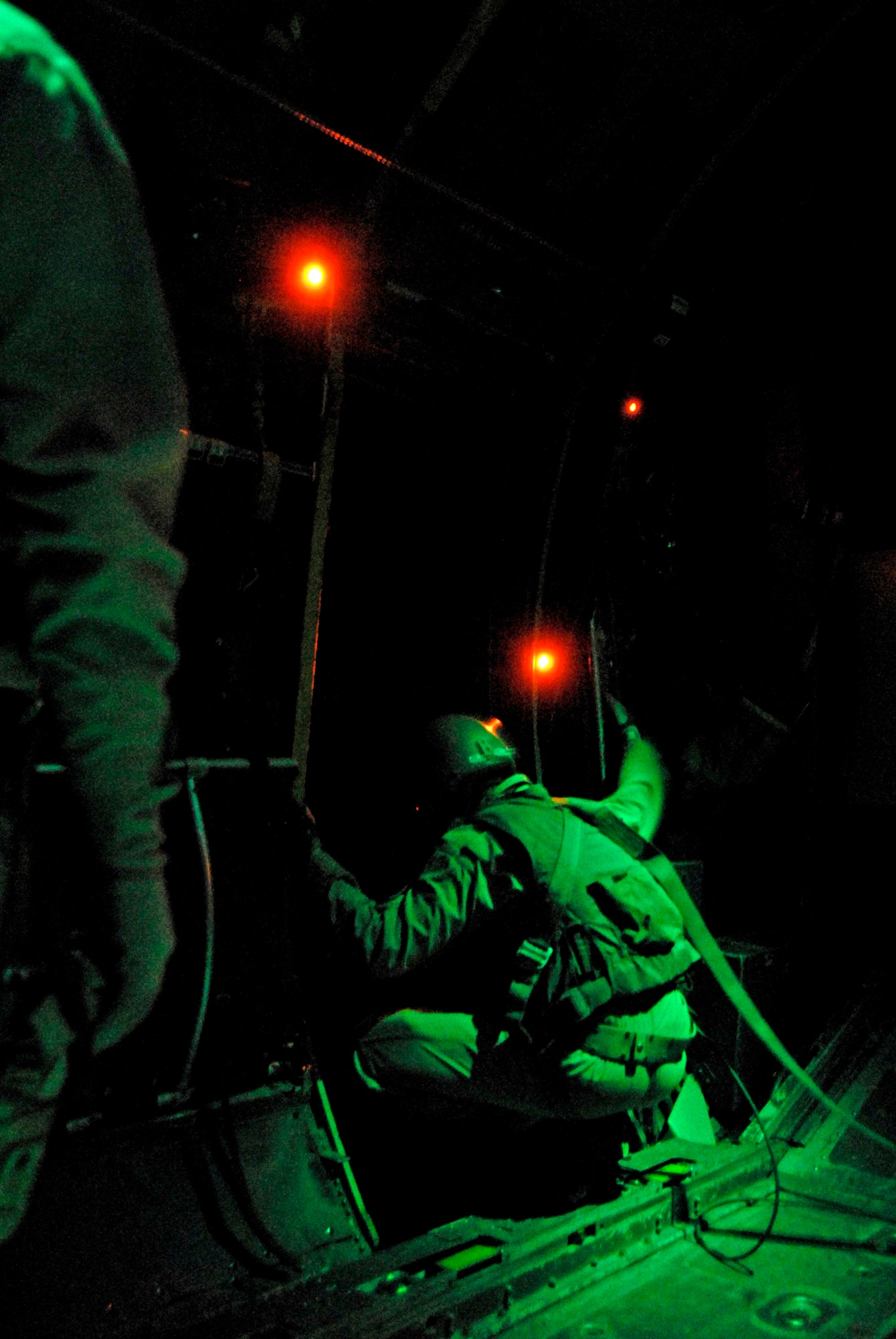 Staff Sgt. Gabriel Molanders gazes at the cities below following the airdrop of several hundred thousand leaflets from a C-130 Hercules over an Iraqi city recently. Sergeant Molanders is a C-130 loadmaster with the 737th Expeditionary Airlift Squadron and deployed from Dyess Air Force Base, Texas. (U.S. Air Force photo/Tech. Sgt. Michael O'Connor) 
