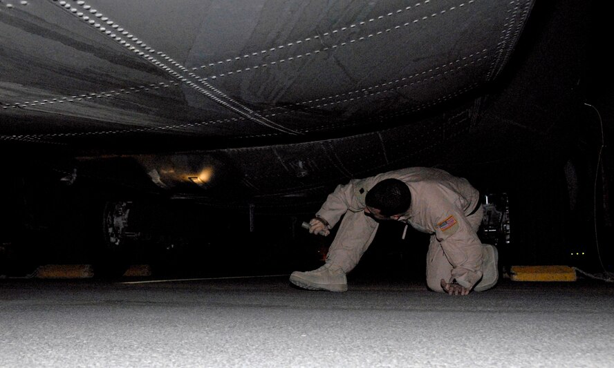 Staff Sgt. James Rice performs a preflight inspection of a C-130 Hercules at an air base in Southwest Asia prior to a leaflet airdrop mission over Iraq. Sergeant Rice is a C-130 engineer deployed with the 737th Expeditionary Airlift Squadron deployed from Dyess Air Force Base, Texas. (U.S. Air Force photo/Tech. Sgt. Michael O'Connor) 
