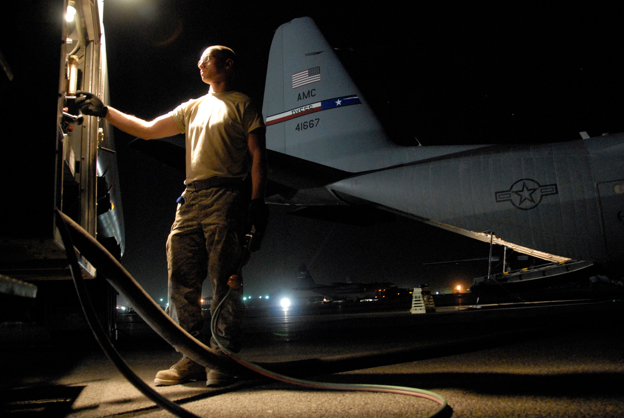 Senior Airman Brian Gunther tops off the tanks of a C-130 Hercules with nearly 2,500 gallons of JP-8 fuel. The refuel operation took place recently on an air base in the Southwest Asia prior to the aircraft departing for a mission to drop several hundred thousand leaflets over an Iraqi city. Airman Gunther is assigned to the 386th Expeditionary Logistics Readiness Squadron Fuels Management Flight and deployed from Royal Air Force Lakenheath, England. (U.S. Air Force photo/Tech. Sgt. Michael O'Connor) 
