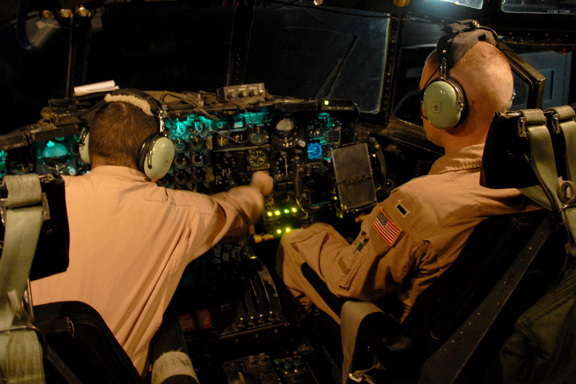 SOUTHWEST ASIA -- Staff Sgt. James Rice, an Air Force C-130 Hercules engineer and 1st Lt. Justin Fitzpatrick, a co-pilot with the 737th Expeditionary Airlift Squadron, go through a pre-flight checklist to ensure all the control and pressure guages are working on the instrument panel prior to the aircraft's departure on a passenger/cargo mission to Iraq on May 13, 2008. Both Lieutenant Fitzpatrick and Sergeant Rice are deployed from Dyess Air Force Base, Texas. (U.S. Air Force photo/Tech. Sgt. Michael O'Connor)
