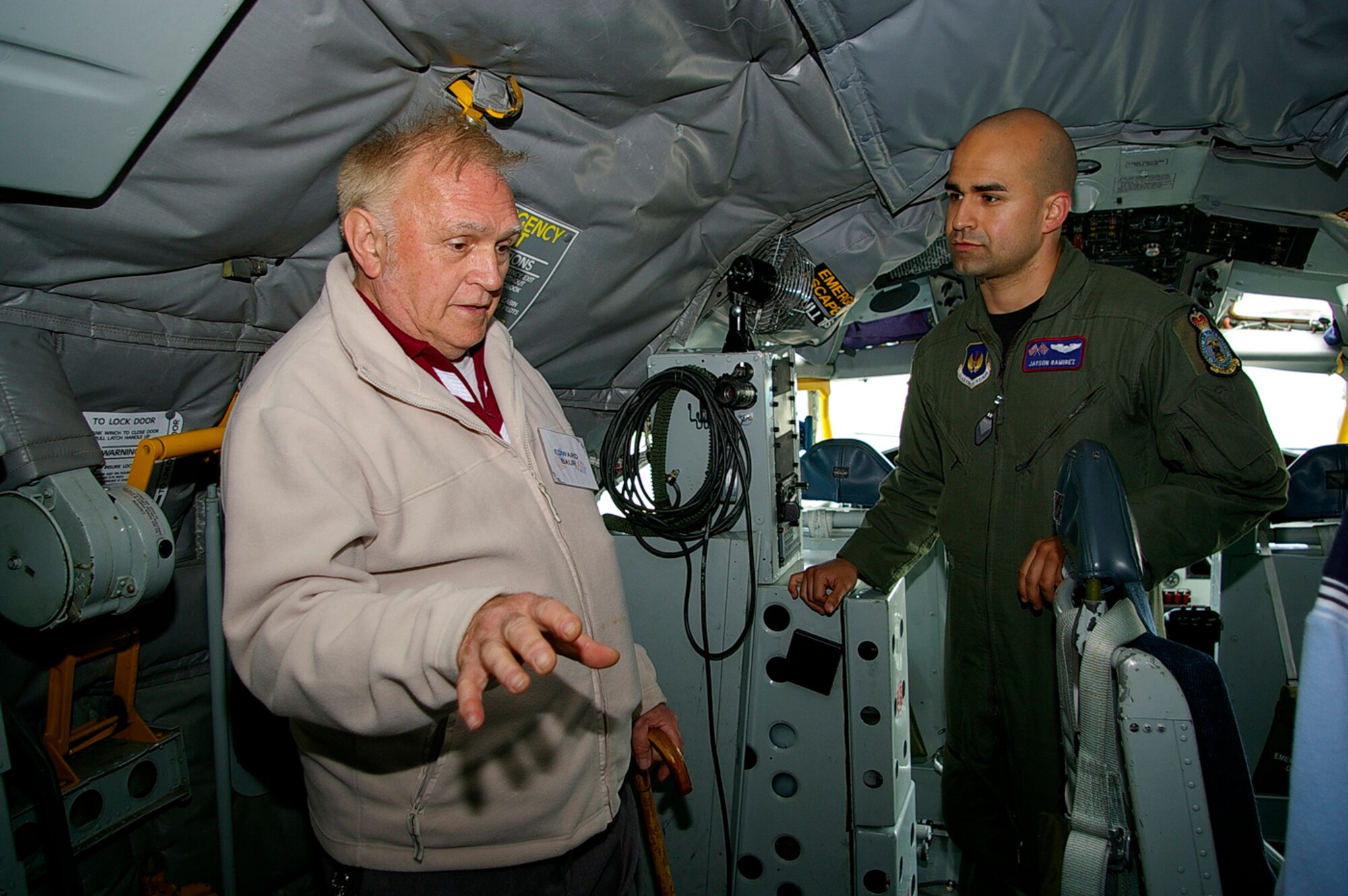 Edward Baur, left, chats about the "old days" when he was in the military, to 1st Lt. Jayson Ramirez, 351st Air Refueling Squadron, May 15, while on board a static KC-135.  Mr. Baur was a boom operator on KC-135s and is a retiree, one of many who attended the Retiree Appreciation Day events at RAF Mildenhall May 14 and 15. Also on display were a C-130 from the 352nd Special Operations Group, and an F-15E from RAF Lakenheath. (U.S. Air Force photo by Karen Abeyasekere)