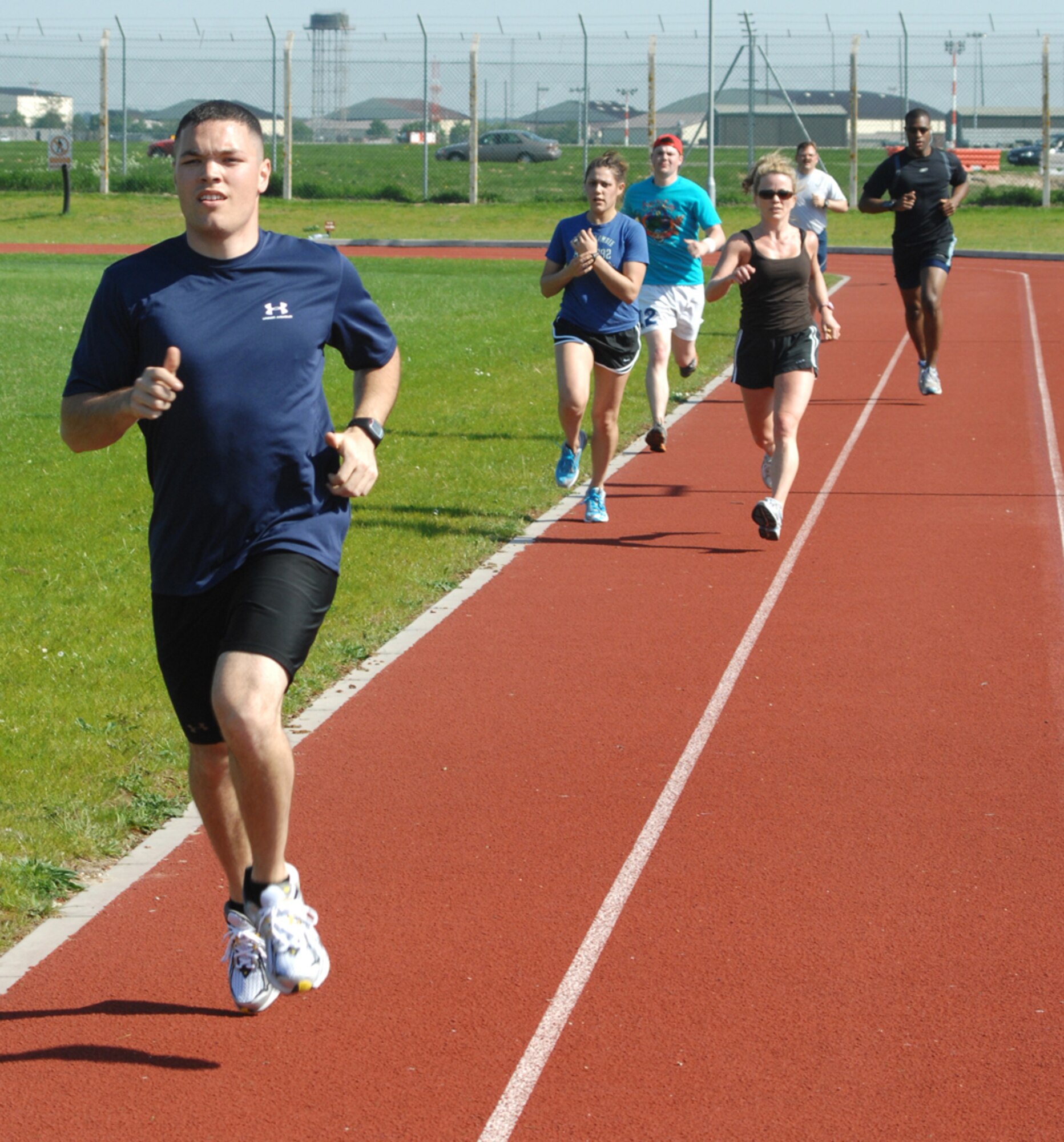 Senior Airman Zeb Willoghby breaks away from the pack during a weekly meeting of the Mildenhall Running Club, May 8 at the Heritage Park running track. The club meets at the Hardstand Fitness Center Tuesdays at 3:30 p.m. for an endurance run of 2-6 miles and every Thursday at the base track for speed work. Runners of all abilities and experience levels are welcome. For more information, contact 1st Lt. Anthonelli White at DSN 238-5873. (U.S. Air Force photo by Tech. Sgt. Eric Petosky)
