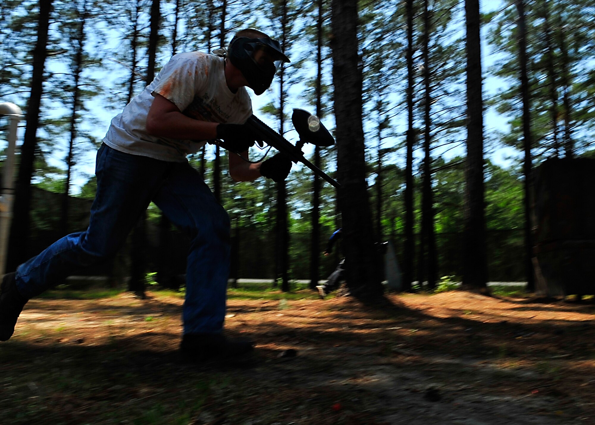 MOODY AIR FORCE  BASE, Ga. -- Airman 1st Class Andrew Stout, 23rd Security Forces Squadron member, runs towards a bunker for cover during a paintball match here May 14. Members of the 23rd SFS held a paintball tournament at Splatter Swamp paintball range during Police Week. (U.S. Air Force photo by Airman 1st Class Brittany Barker)