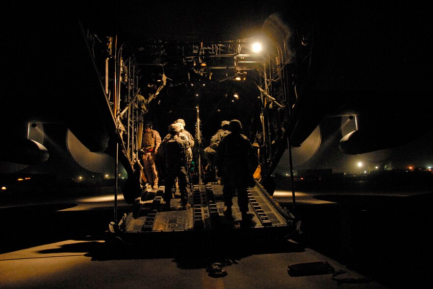 SOUTHWEST ASIA -- Senior Airman Joel Pfaff, a C-130 Hercules loadmaster with the 737th Expeditionary Airlift Squadron, stands next to the rear left troop cargo door ensuring all passengers make it onboard safely during a passenger/cargo mission to an air base in Iraq May 13, 2008. Airman Pfaff is deployed from Dyess Air Force Base, Texas, and the Soldiers returning home from a 14-month-deployment are from the A-Battery, 1-10 Field Artillery, 3rd Brigade Combat Team, 31st Division out of Fort Benning, Ga. (U.S. Air Force photo/Tech. Sgt. Michael O'Connor)