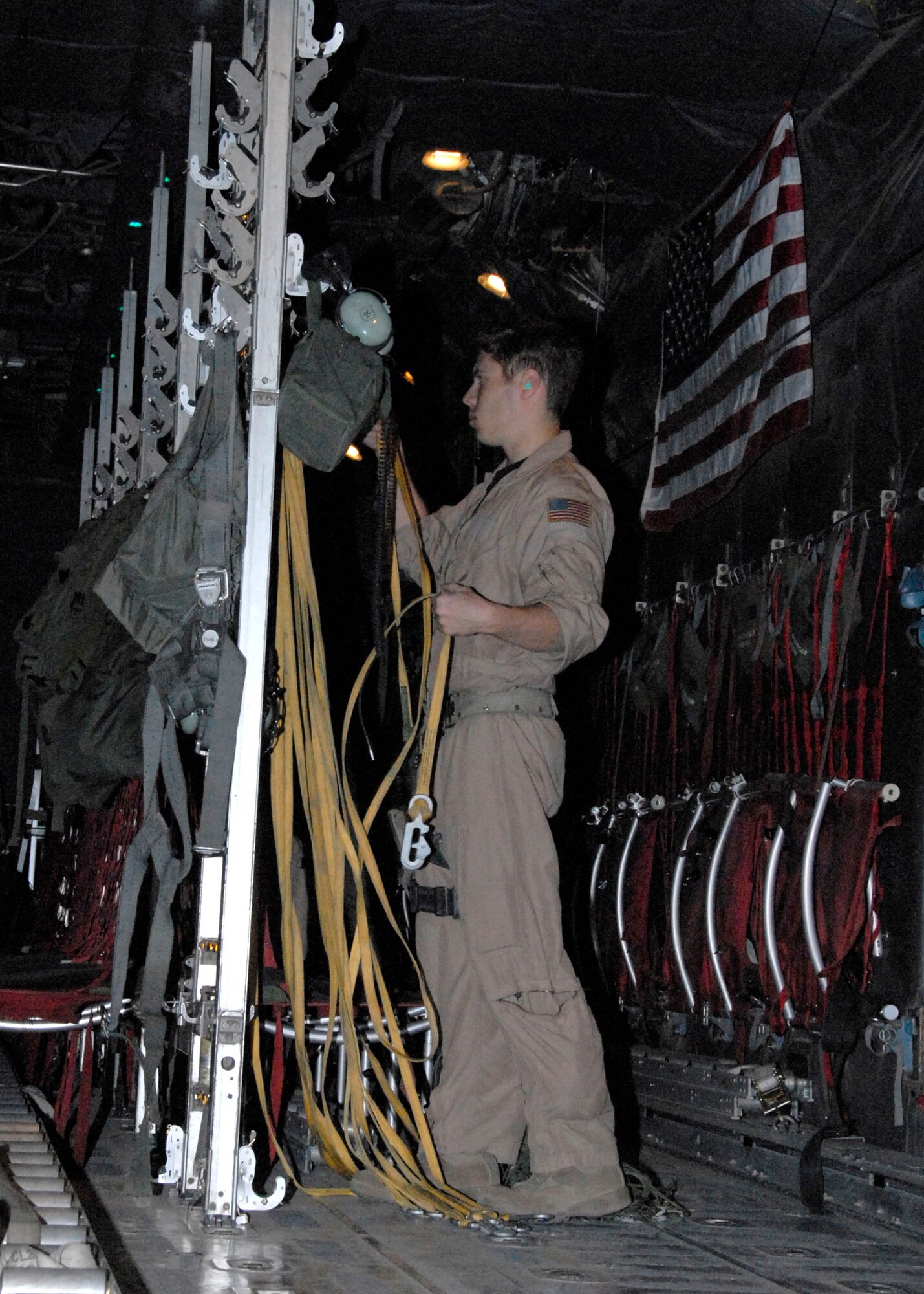 SOUTHWEST ASIA -- Staff Sgt. Gabriel Molanders, an Air Force C-130 Hercules loadmaster puts away the static lines used in airdropping several hundred thousand leaflets over an Iraqi city in May 2008. Sergeant Molanders, with the 737th Expeditionary Airlift Squadron, is deployed from Dyess Air Force Base, Texas. (U.S. Air Force photo/Tech. Sgt. Michael O'Connor)