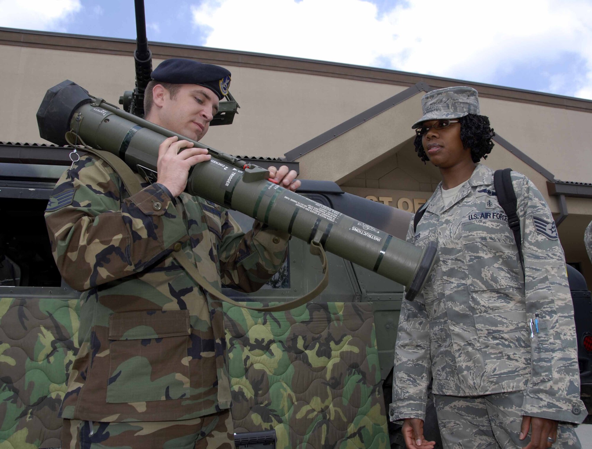 OSAN AIR BASE, Republic of Korea – Staff Sgt. John Quinley, (left), 51st Security Forces Squadron, explains to Staff Sgt. Rikina Gunter, 51st Medical Operations Squadron, how the AT4 anti-tank rocket launcher works during a weapons display May 14. The 51st SFS hosted various events around base in honor of National Police Week, May 11 to 16. (U.S. Air Force photo by Senior Airman Christopher Boitz)